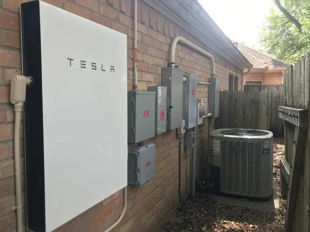 Tesla Powerwall home battery backup installed on the side of a home