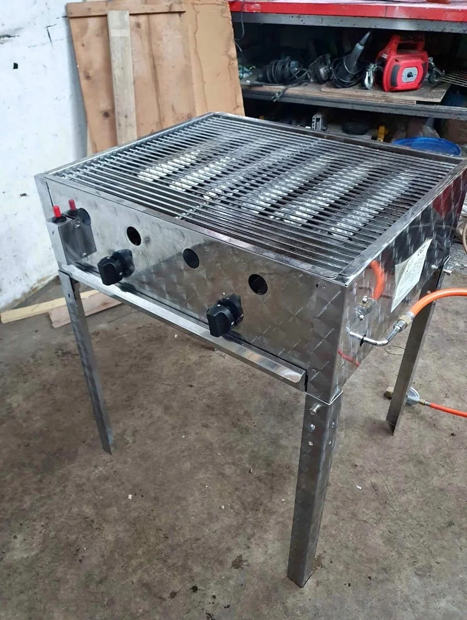 Metal gas grill in workshop setting