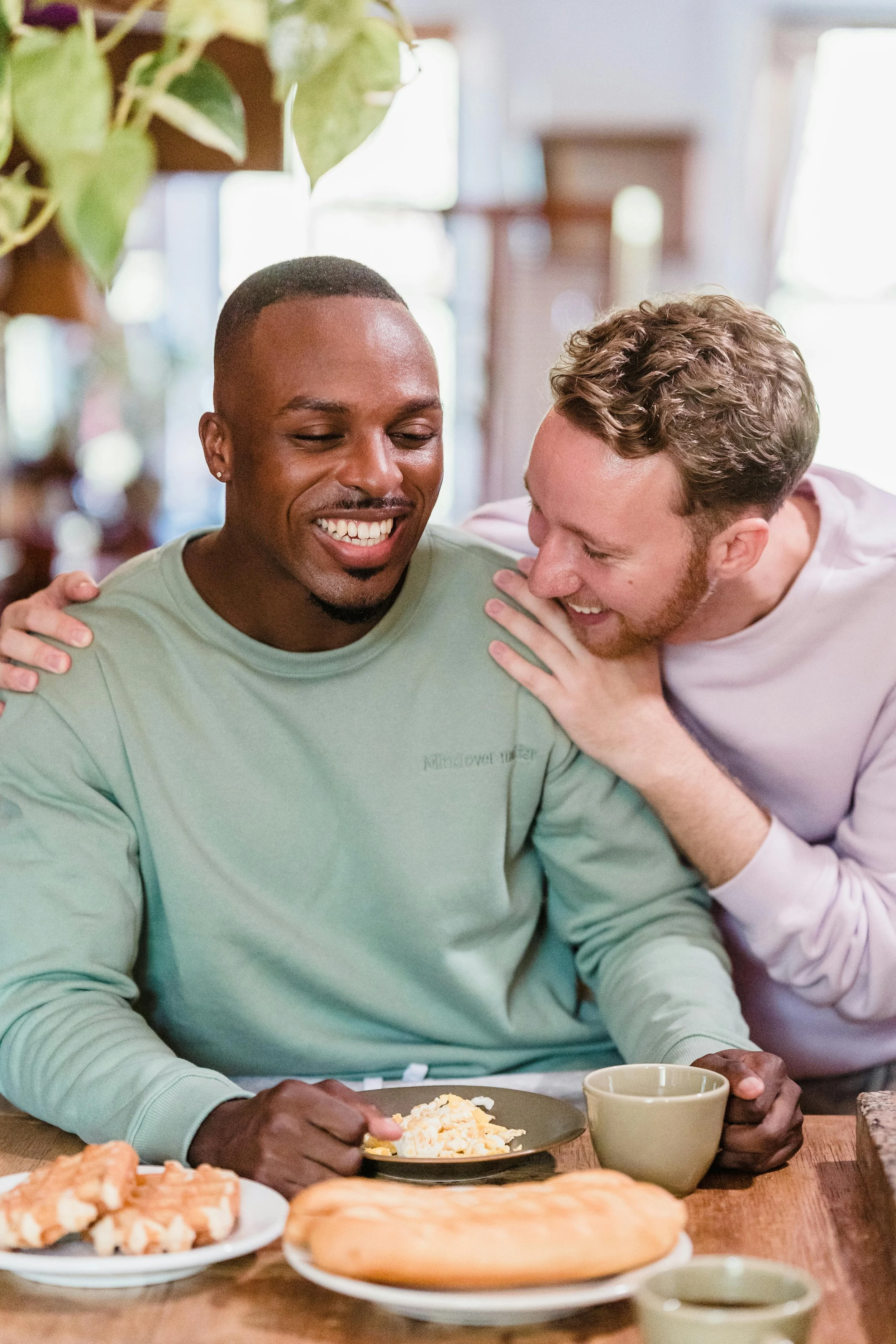 Close-up of two men's hands during a gentle, supportive touch