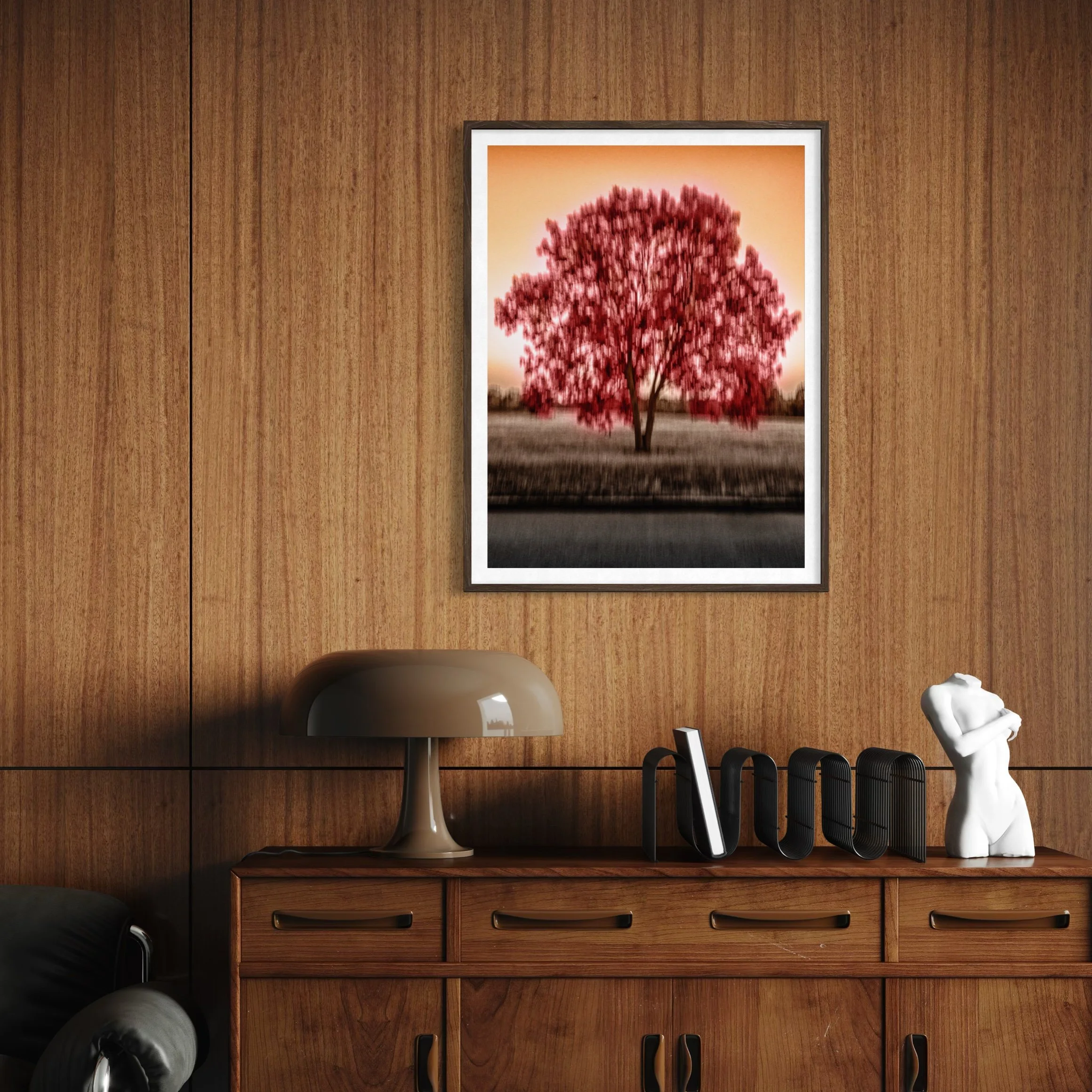 The Tree of Passion, framed abstract ICM photograph displayed above a mid-century wooden sideboard in a warm wood-panelled interior.