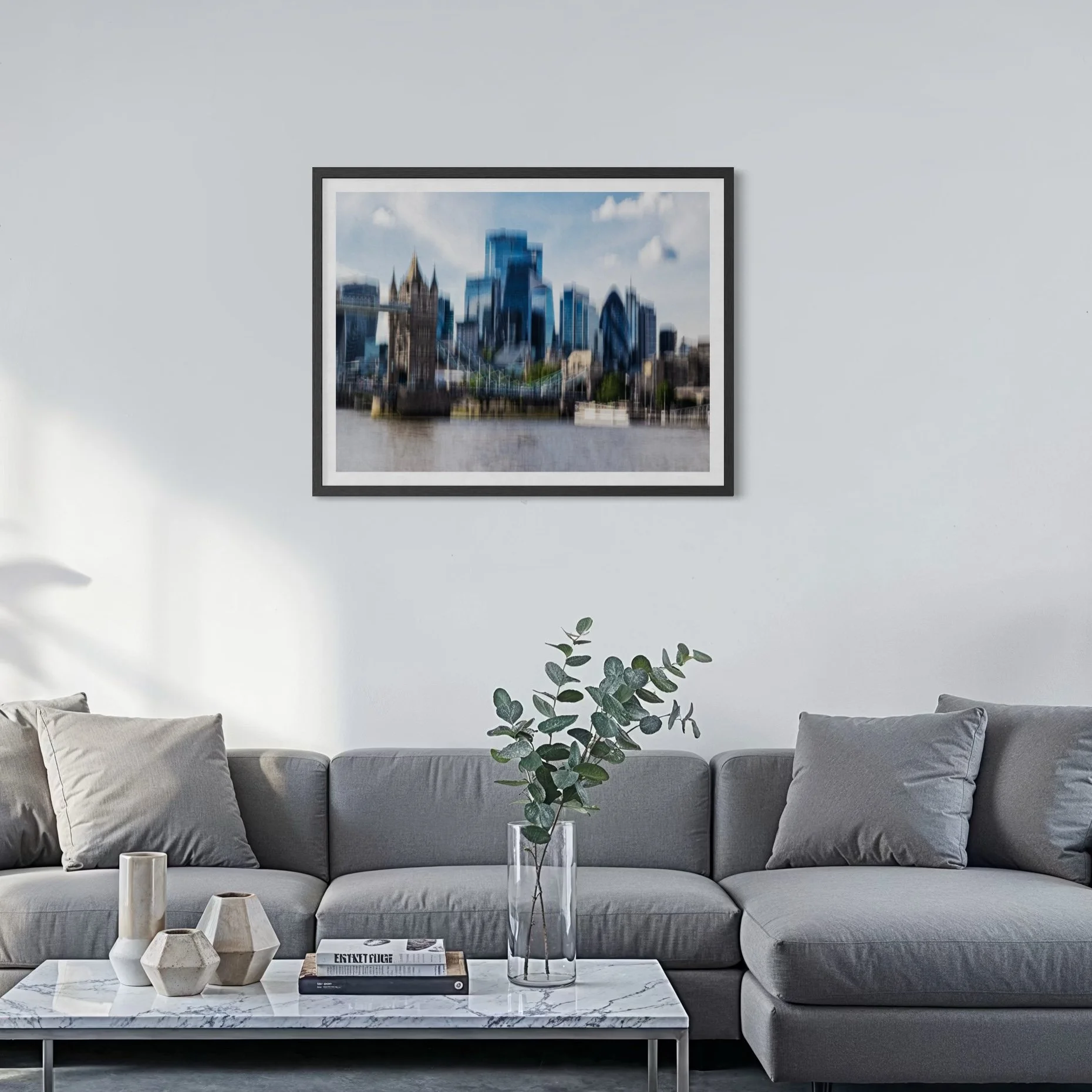Abstract London wall art displayed above a grey sofa in a modern minimalist living room interior.