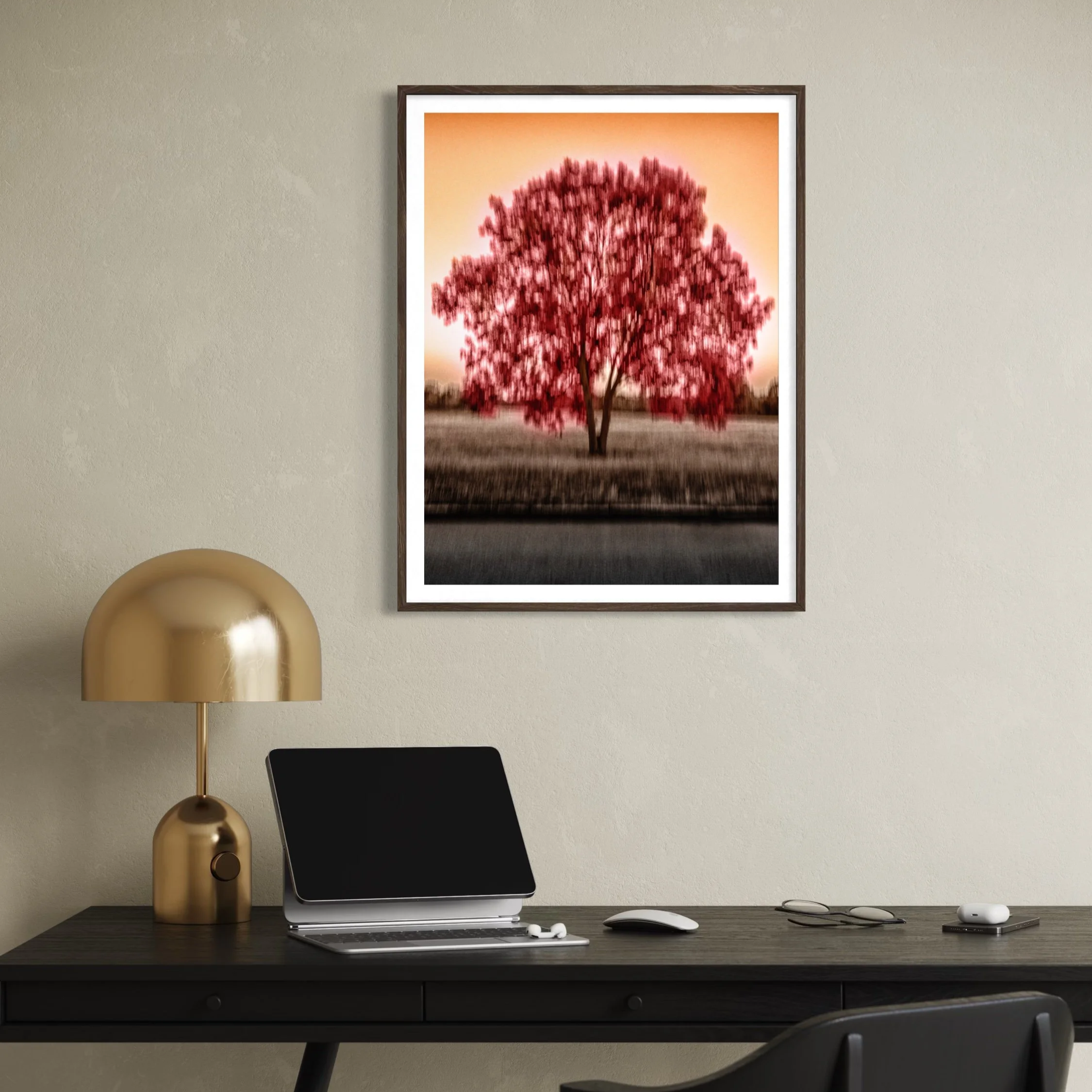 The Tree of Passion, framed abstract ICM art print above a dark desk with brass lamp in a warm modern home office.