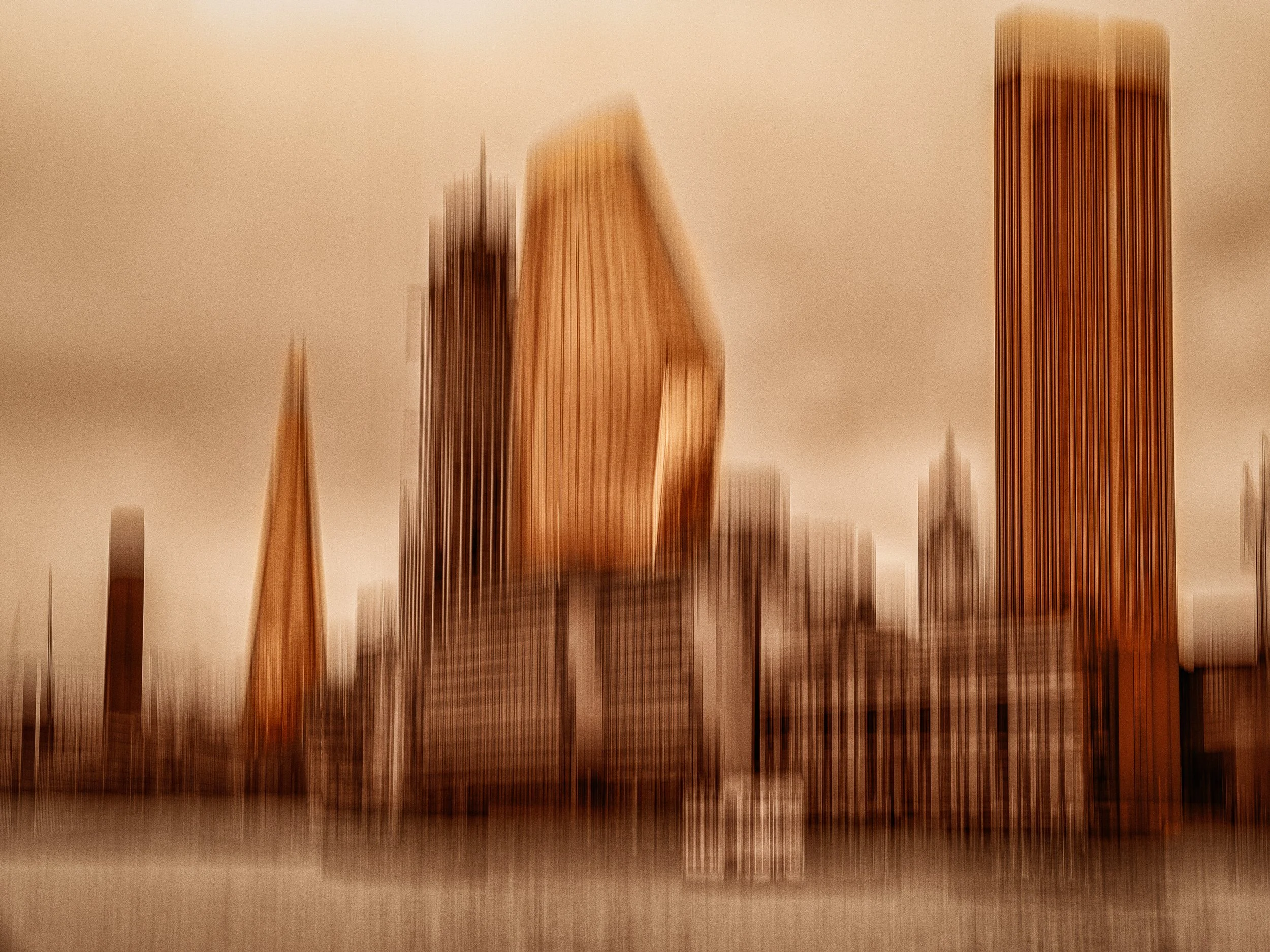 Skylines in Sepia and Orange – Duotone abstract ICM photograph of a blurred city skyline glowing in sepia depth and fiery orange motion.