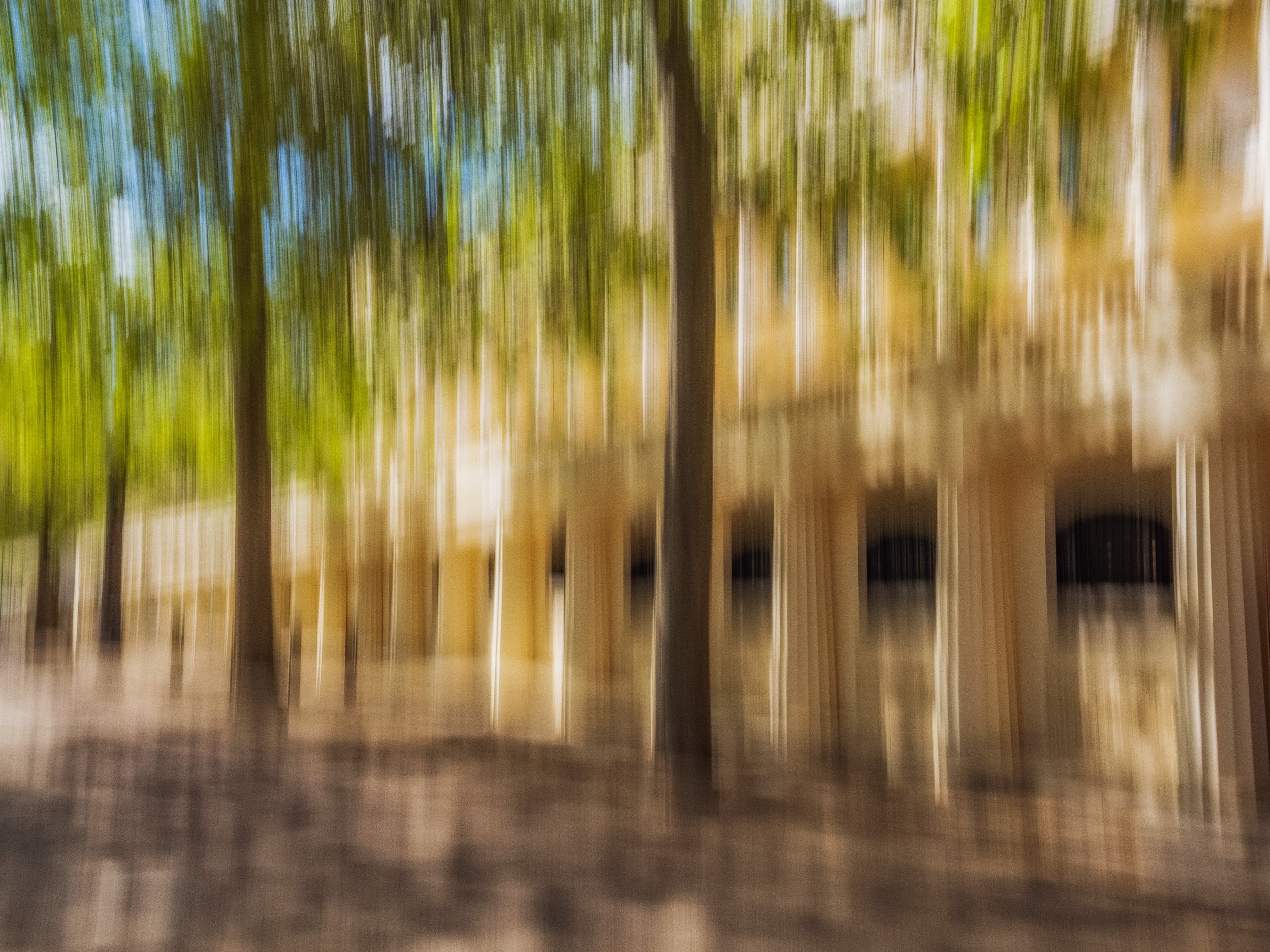 Shades of a Summer Walk – abstract ICM photography print with beige columns and a tree-lined summer path, where motion blur blends stone and green into painterly rhythm.