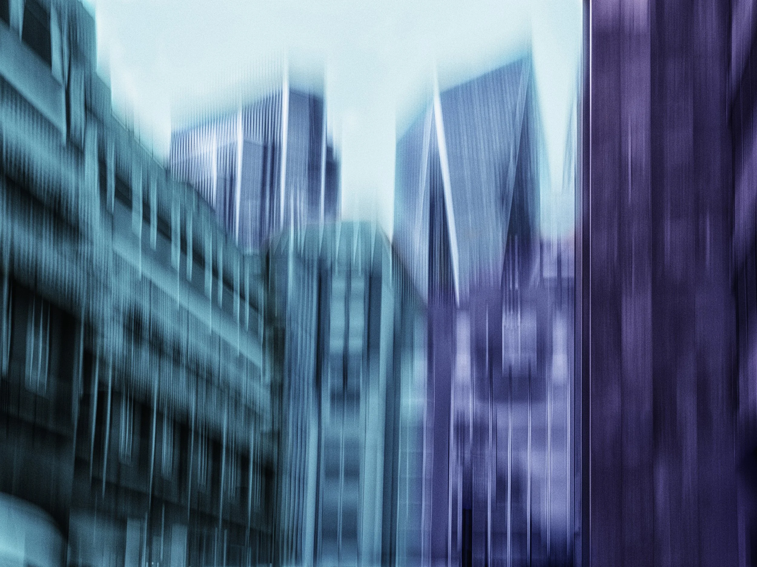 Between Blue and Violet – Abstract ICM cityscape in cyan, blue, and violet tones, blurred skyscrapers with flowing motion and spiritual contrast.