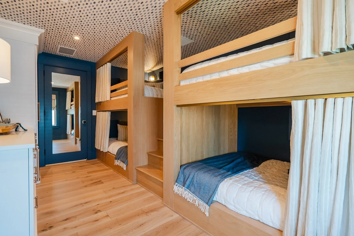 The coziest bunk room we&rsquo;ve done to date! Something about the wallpapered ceilings, wood tones, and privacy curtains makes this space so timeless and inviting. 🌔🌘🌗
