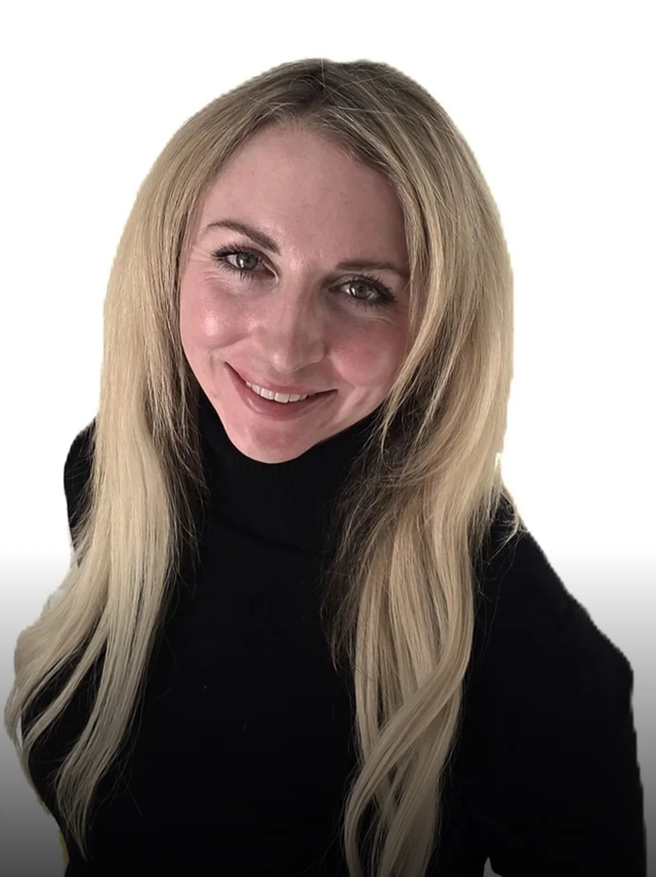 A woman with long blonde hair wearing a black turtleneck sweater, smiling, with a white background.