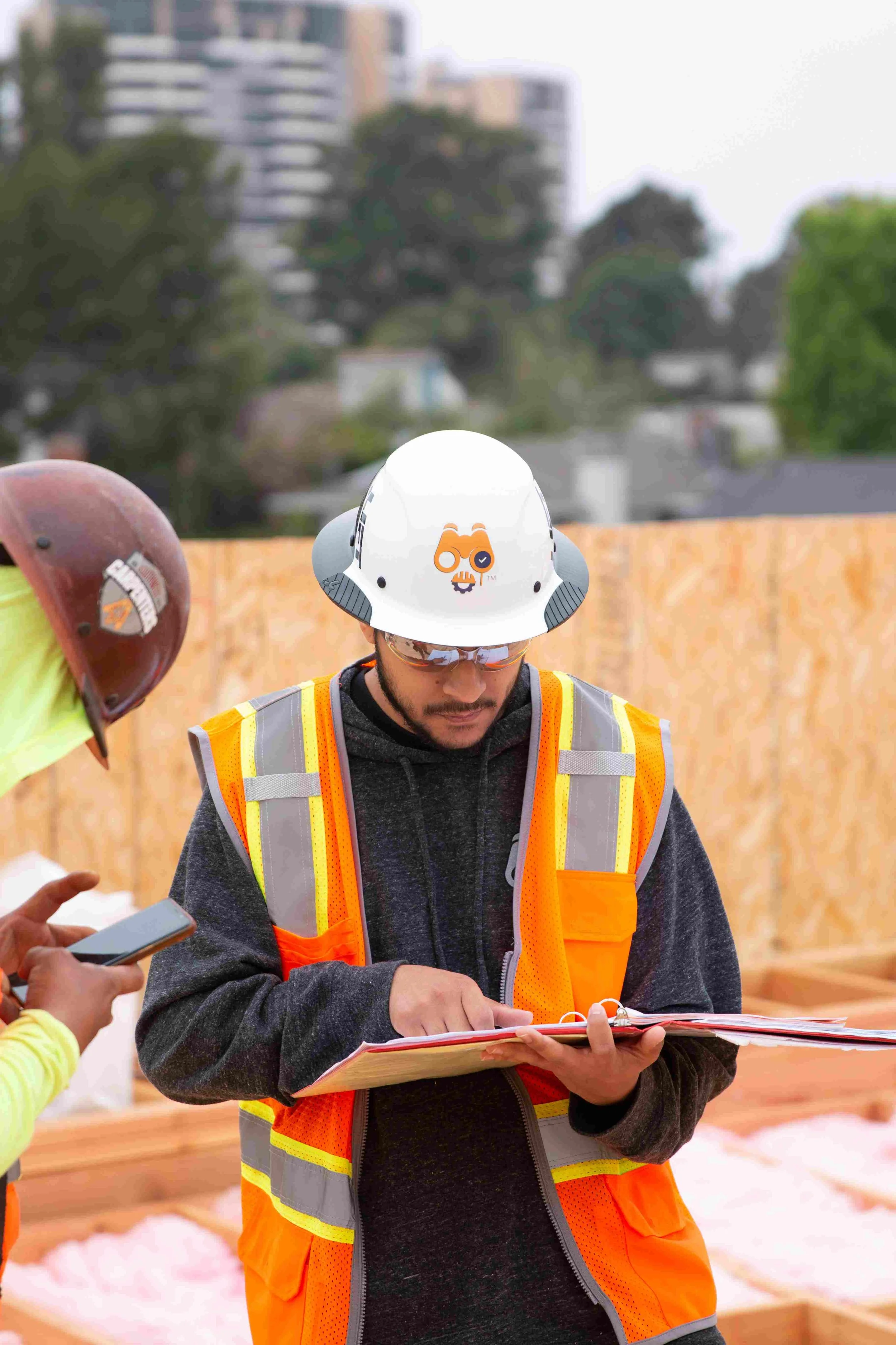 Labor compliance team reviewing certified payroll documents on site