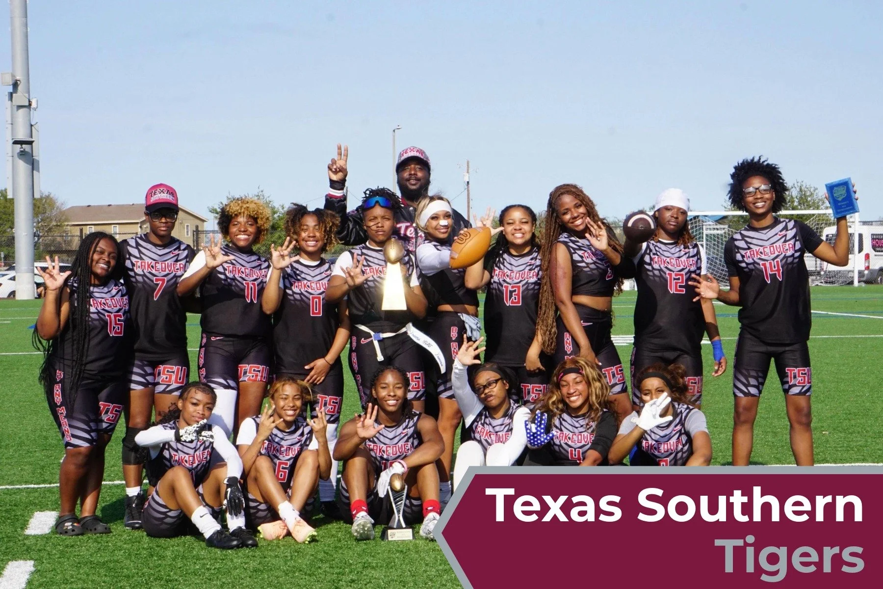 A girls' football team called Texas Southern Tigers posing for a group photo on a football field, some players holding footballs, one player with a trophy, celebrating their victory.