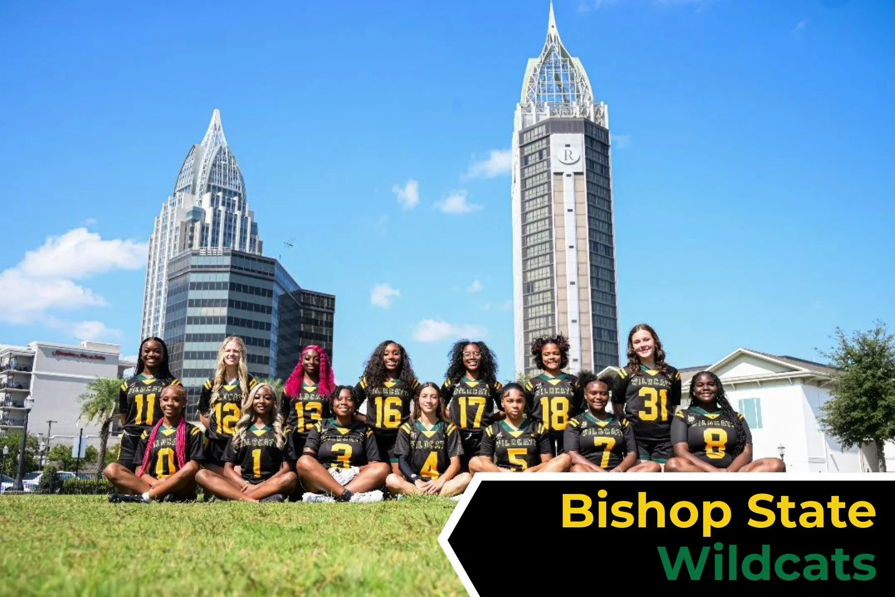 Group of Bishop state women's flag football players in matching black and yellow uniforms sitting on grass