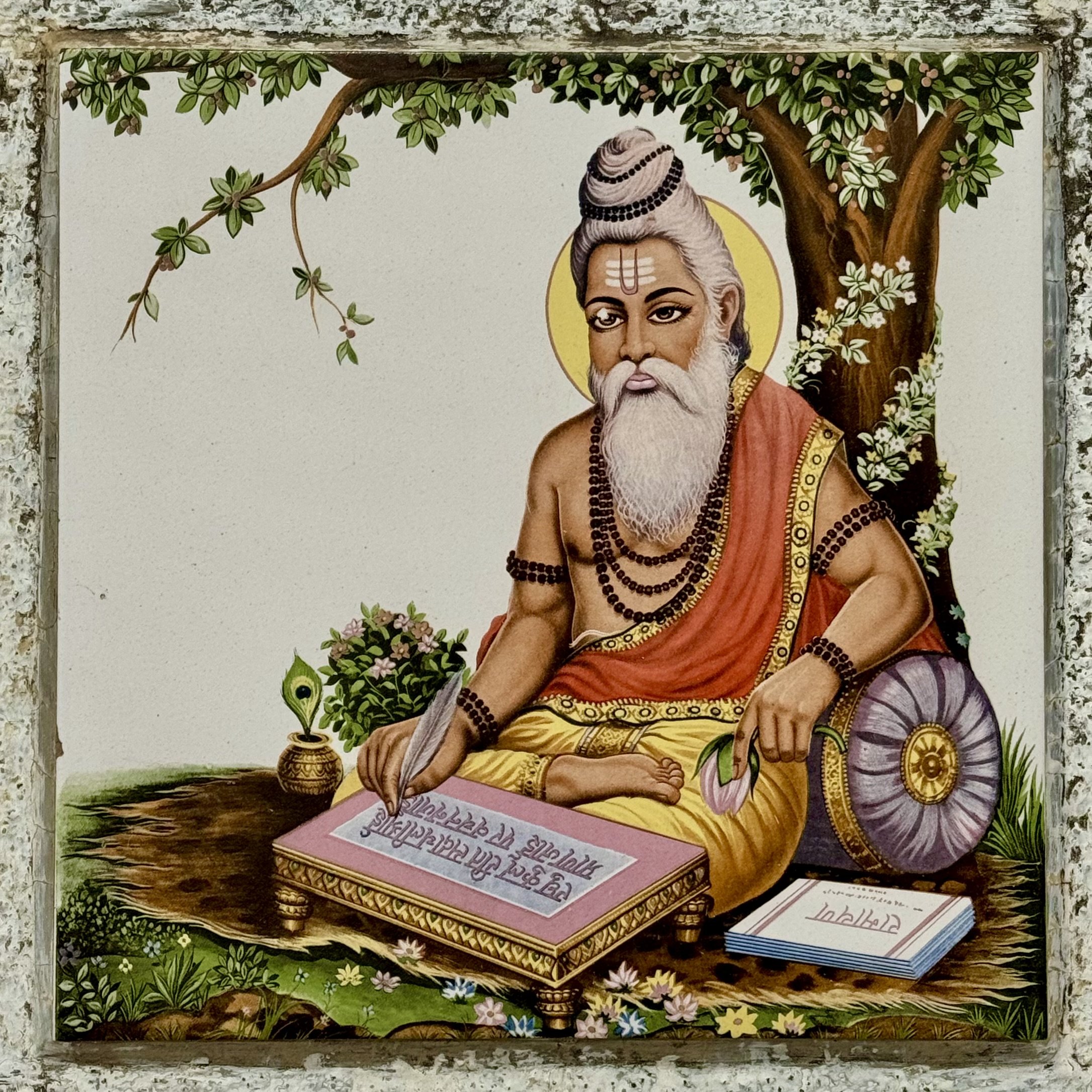 Illustration of a sage with a white beard and traditional attire, sitting under a tree, holding a quill and writing on a scroll. Books and a shield are nearby.