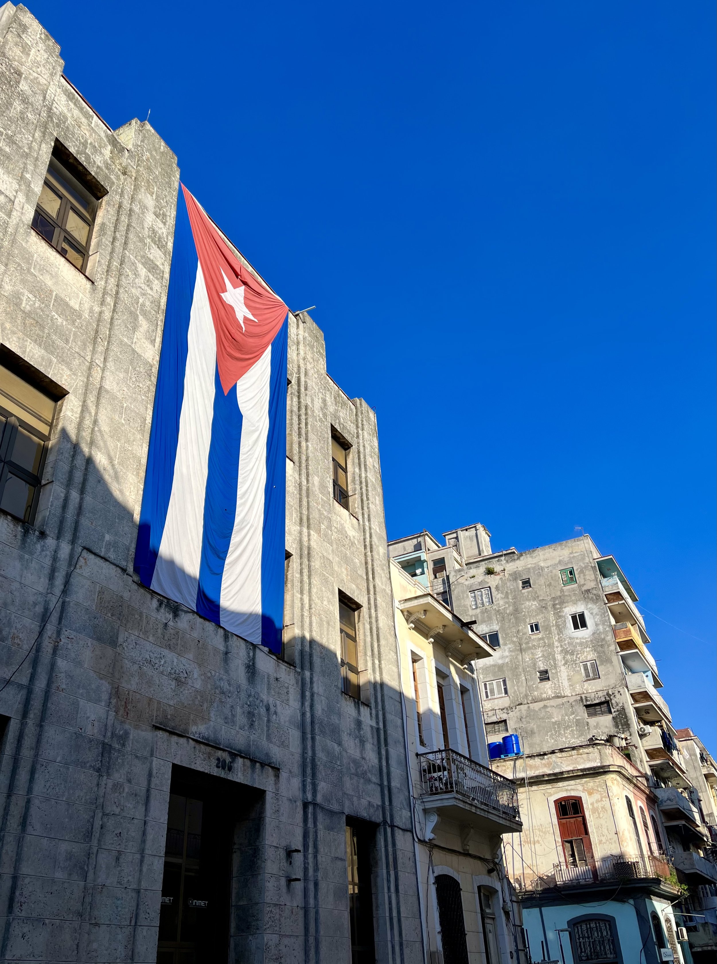 Cuban flag on a building in Havana under a clear blue sky