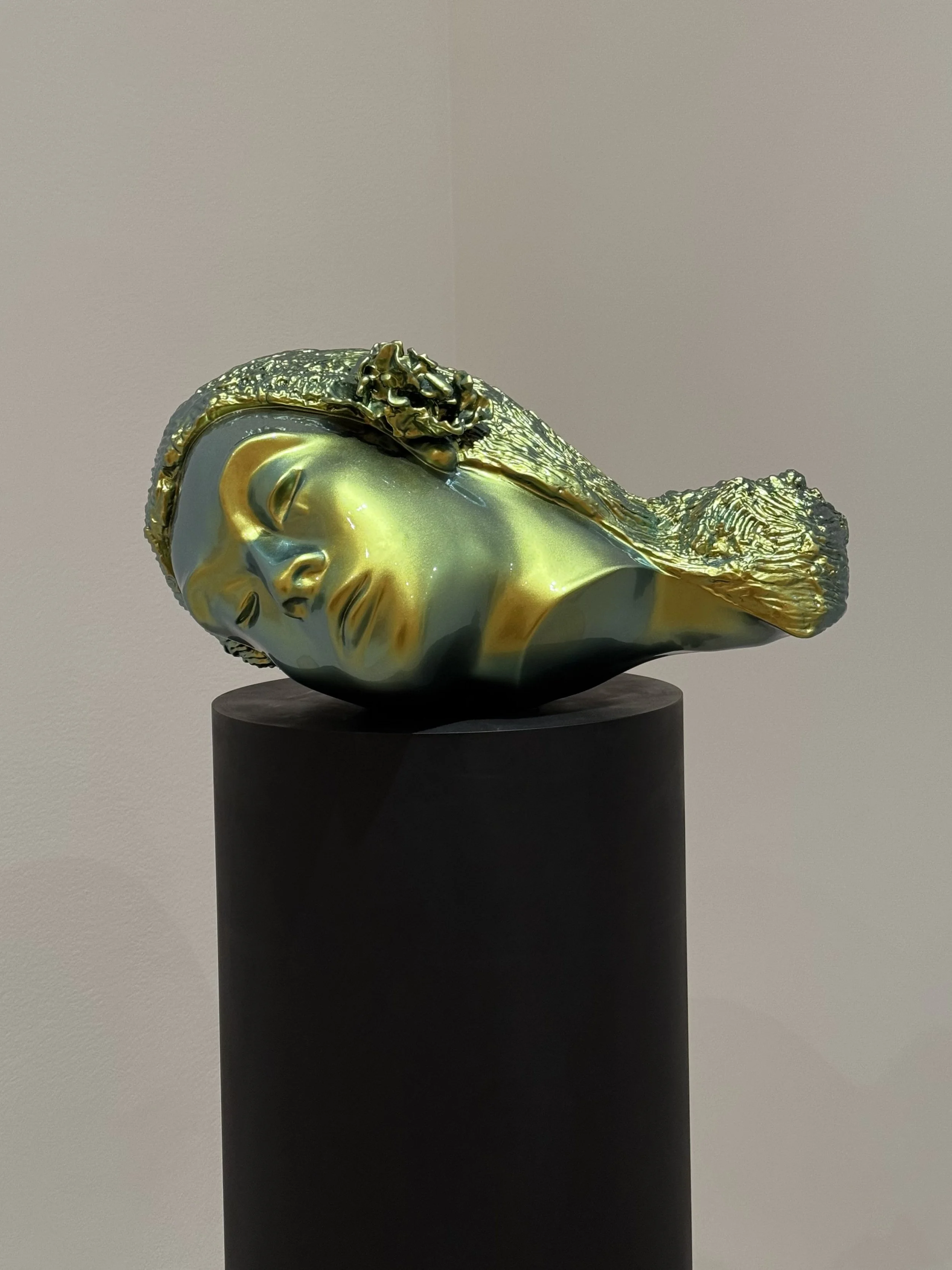 Sculpture of a woman's head with metallic finish