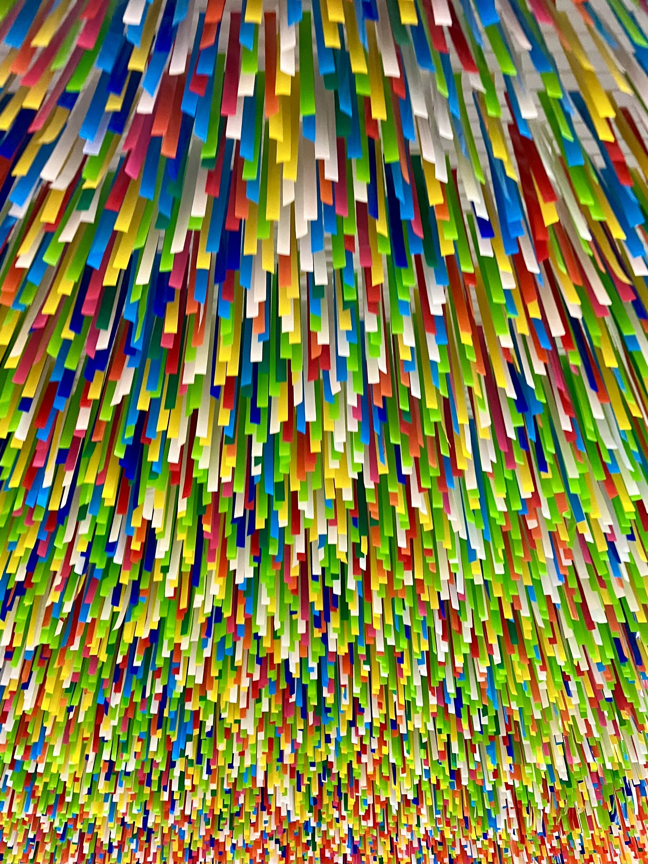 Colorful ceiling art installation with hanging rectangular pieces