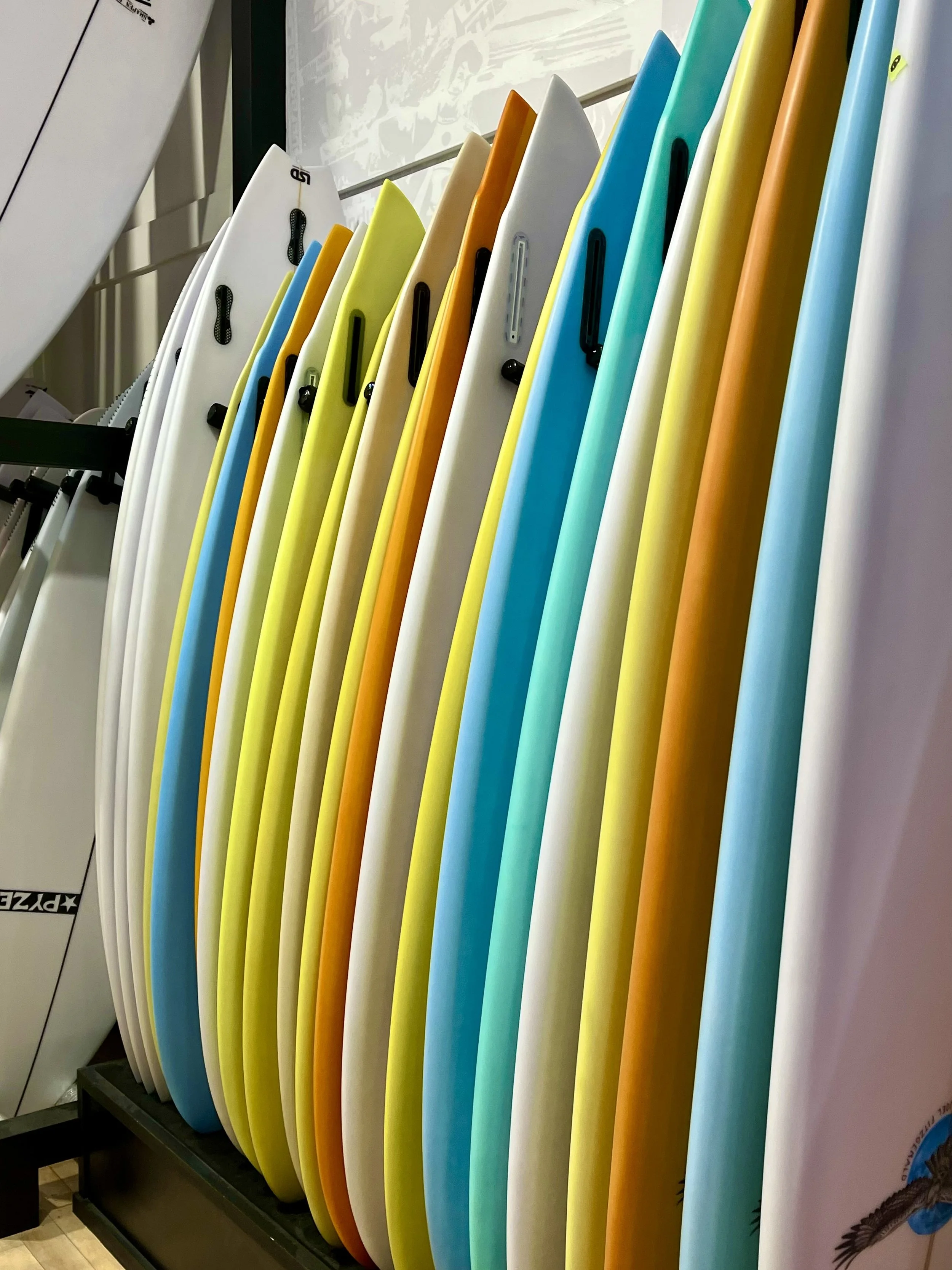 Row of colorful surfboards in a store display in Byron Bay Australia.