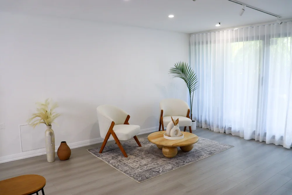 Studio lounge setting with armchairs and a round table