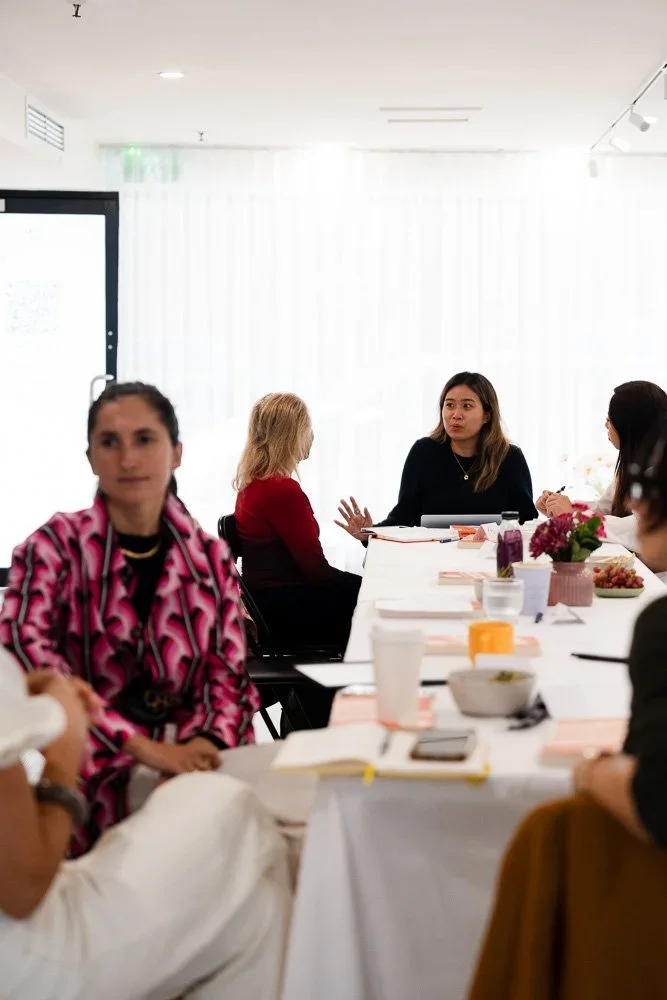 Group seated around a long table at a workshop