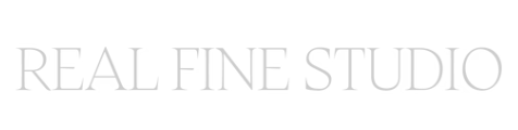 Text that reads 'REAL FINE STUDIO' in a light, elegant font.