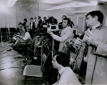 Media at a press conference, filming latest news.