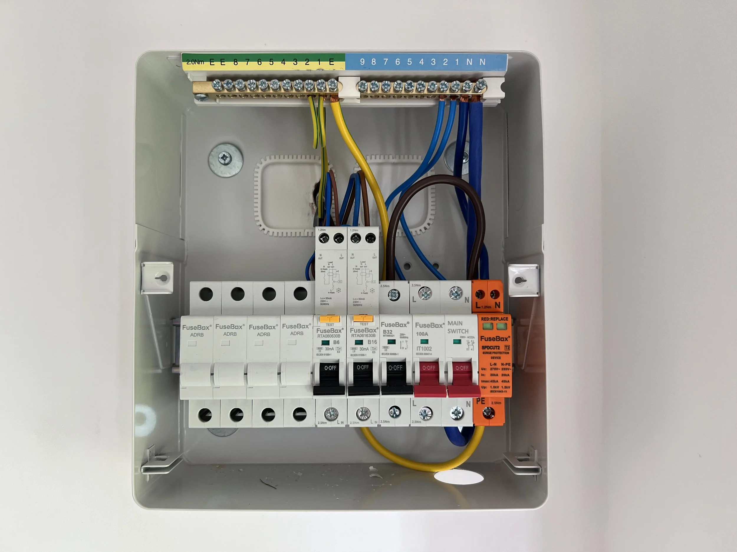 Electrical breaker box with multiple circuit breakers and wiring inside a gray metal enclosure.