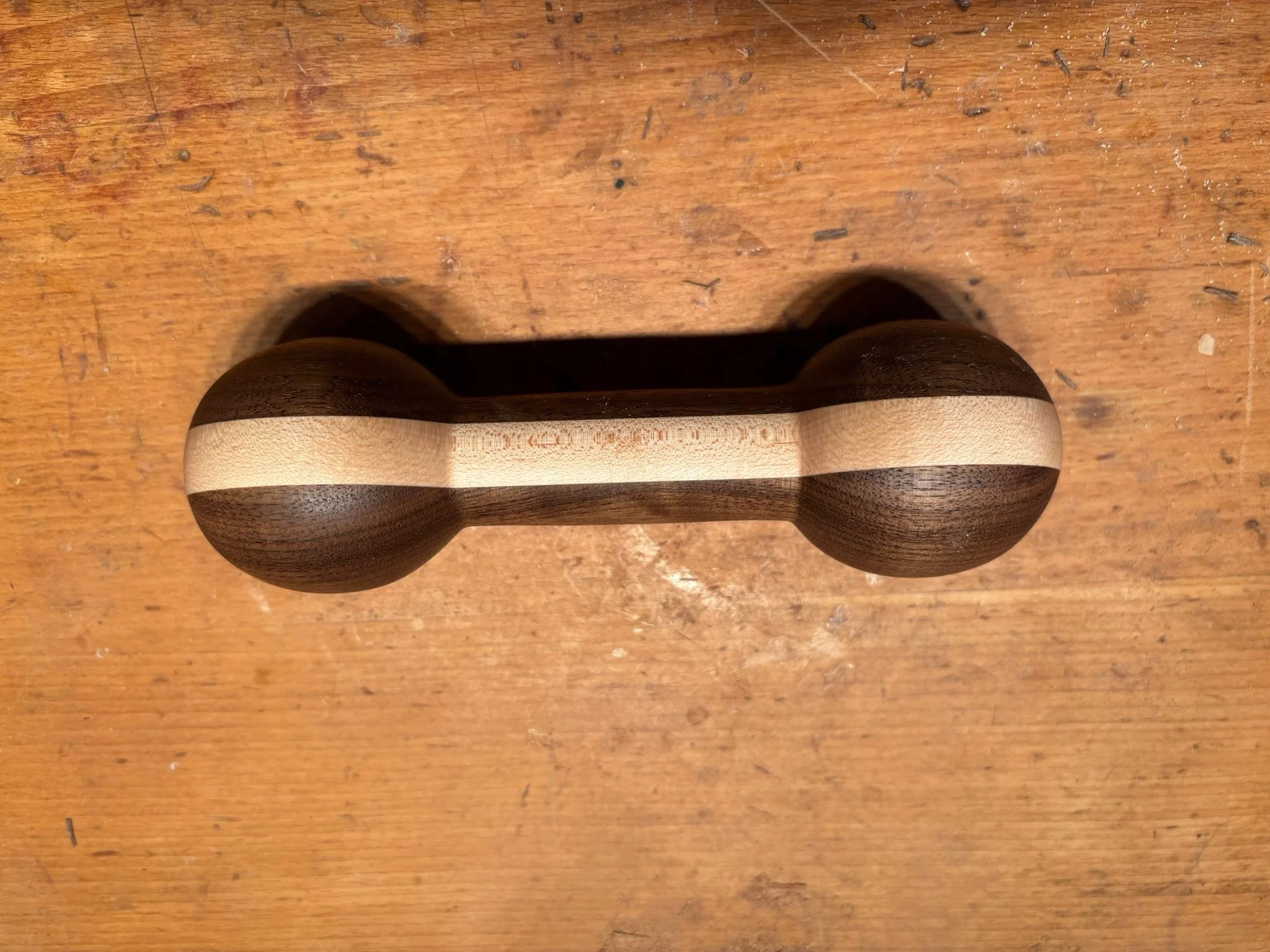 Legolas is having a bit too much fun with this freshly turned black walnut and maple rattle!