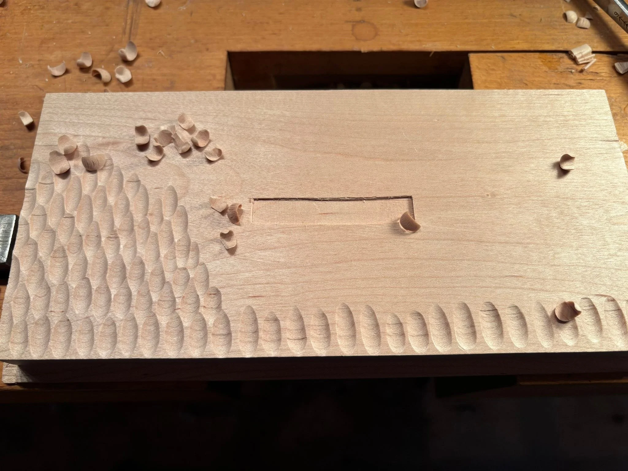 Nice music and a morning of carving.

On to box top number two. Decided to cut a small mortise for the decorative handle.

I know my gouge is sharp when I get the shavings that resemble what we would call &ldquo;rollie-pollies&rdquo; as kids!

When a