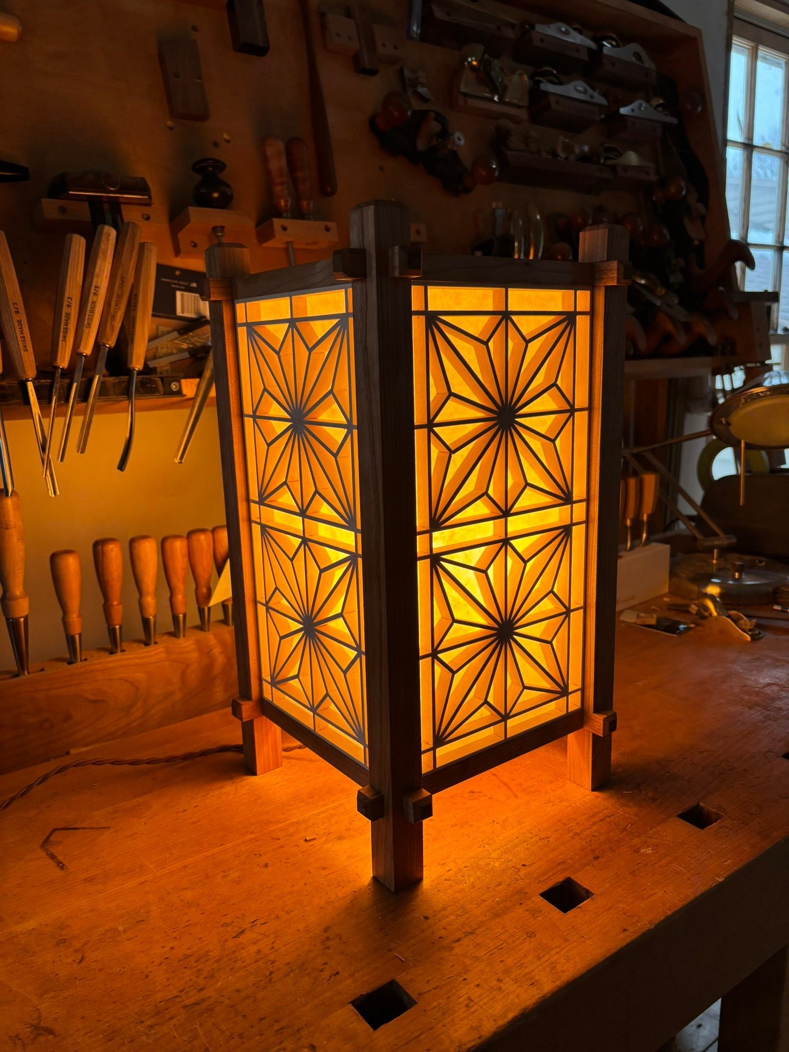 Finished my seventh Kumiko lamp. Customer requested a cherry frame. As with anything else, the more you do something, the better it gets.

Each panel is held in only by friction and they require minuscule trimming with a razor sharp plane. Given the 