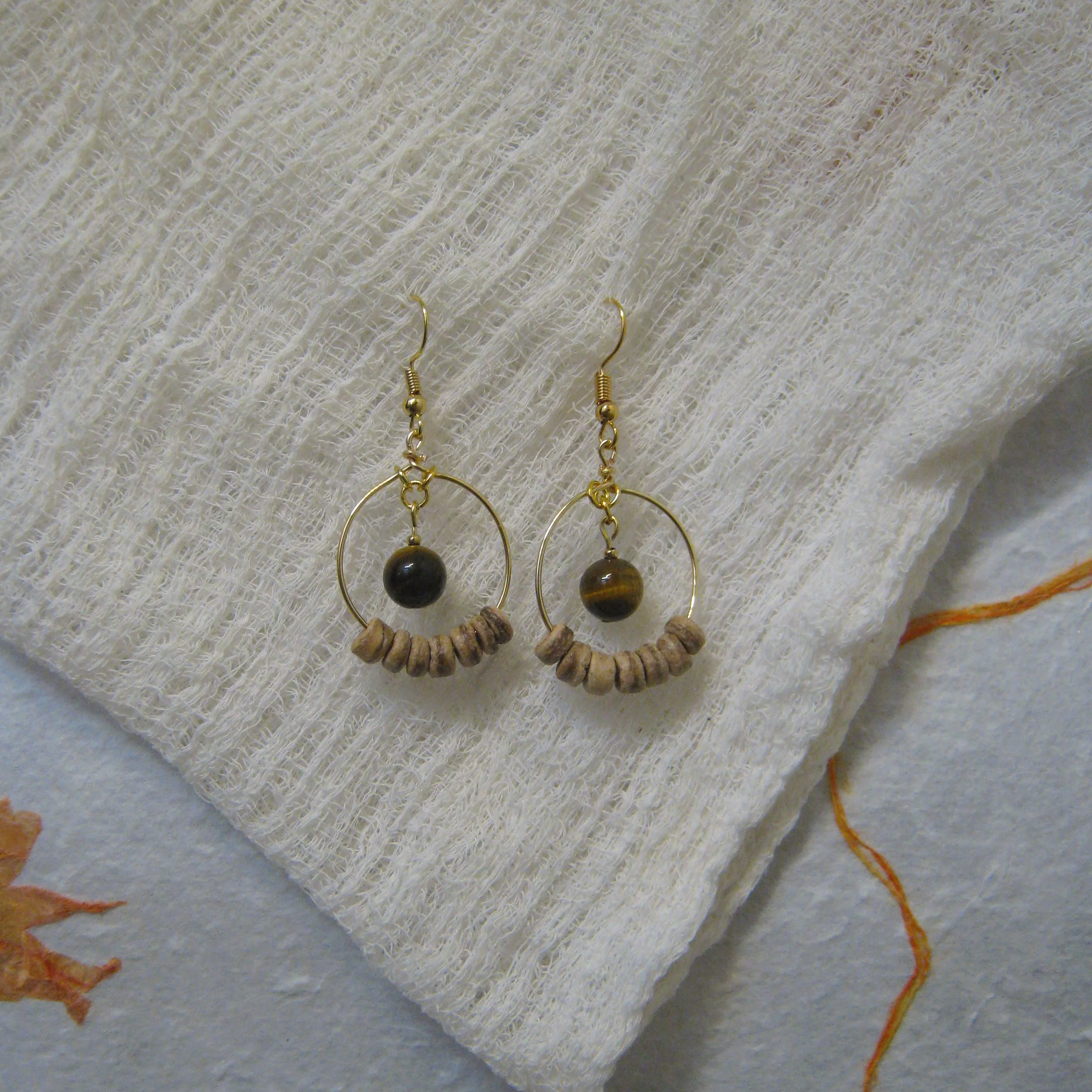 Tigers Eye & Coconut Shell Hoop - $12 | Tigers Eye is associated with courage, strength, and protection. It provides clarity and vision and is known for having grounding energy and vitality. Coconut shell beads are a symbol of sustainability and eco-