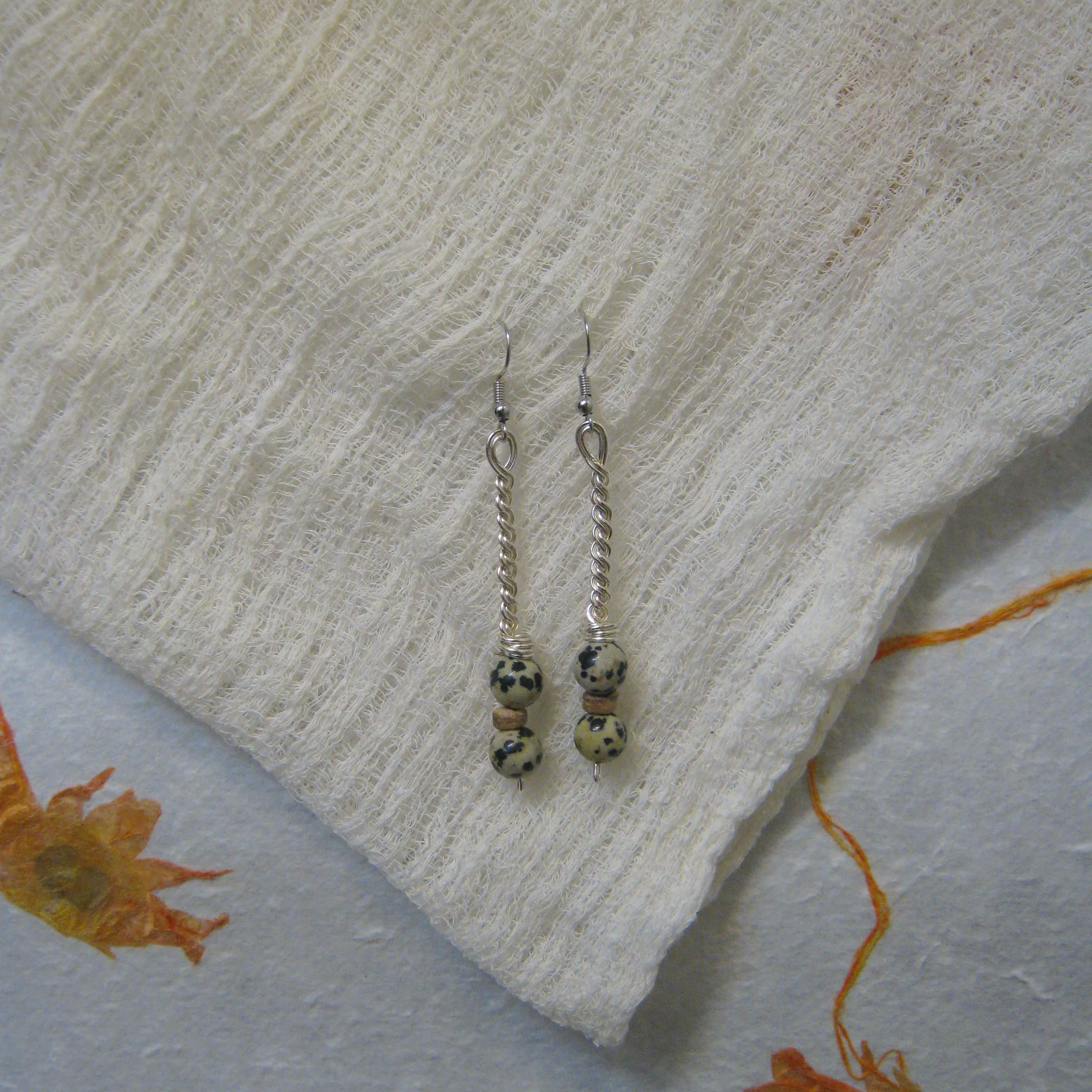 Dalmatian Jasper & Coconut Shell Twisted Chain Stack - $ | Dalmatian Jasper is known for promoting mental sharpness and peaceful feelings of completeness, mastery, and tranquility as well as providing protection and anchoring qualities. 