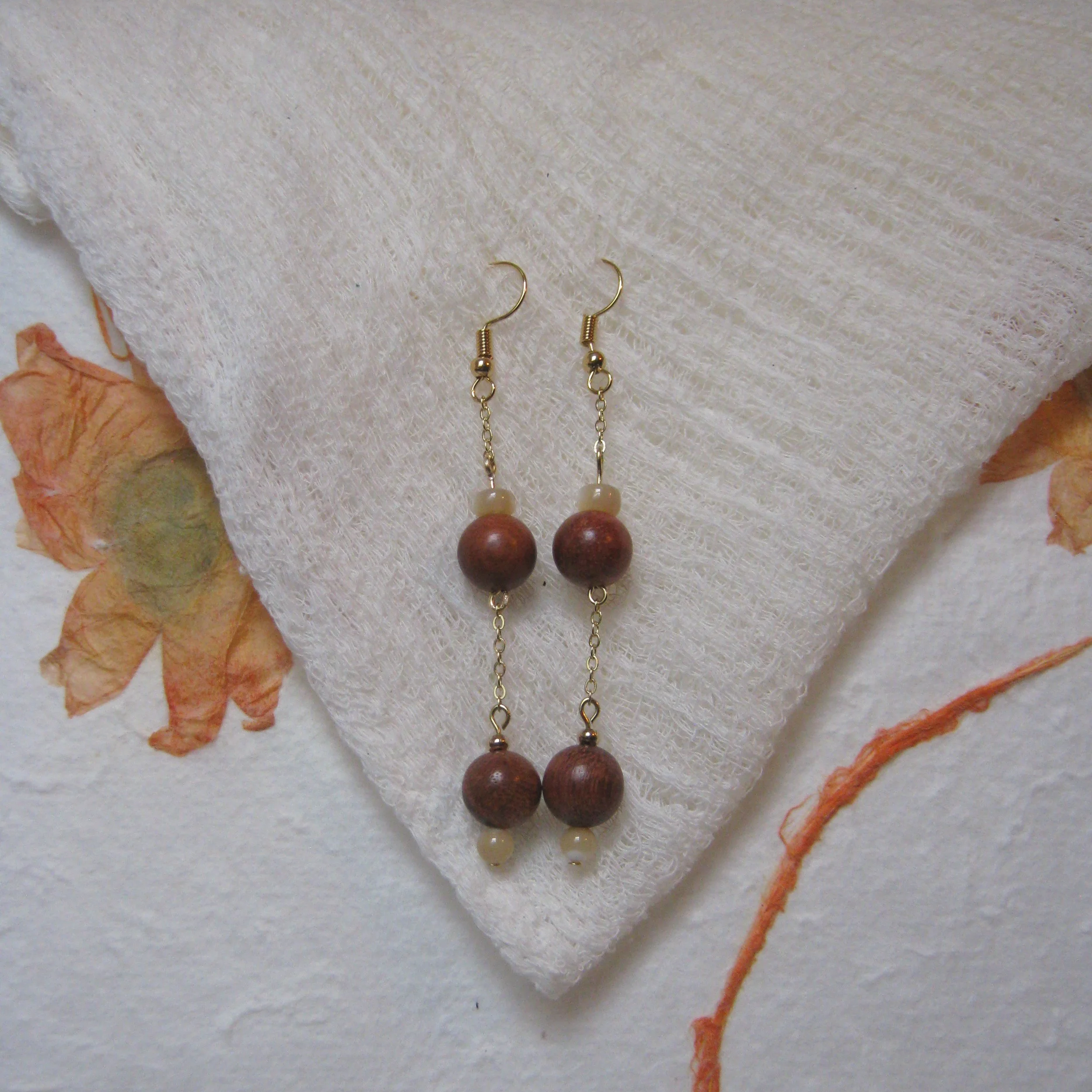 Mother of Pearl Wooden Bead Dangle Earrings - $12 | Wearing wooden beads carries significant symbolism and spiritual meaning across various cultures. These beads connect you to nature and can invite mindfulness and emotional balance, which fosters a 