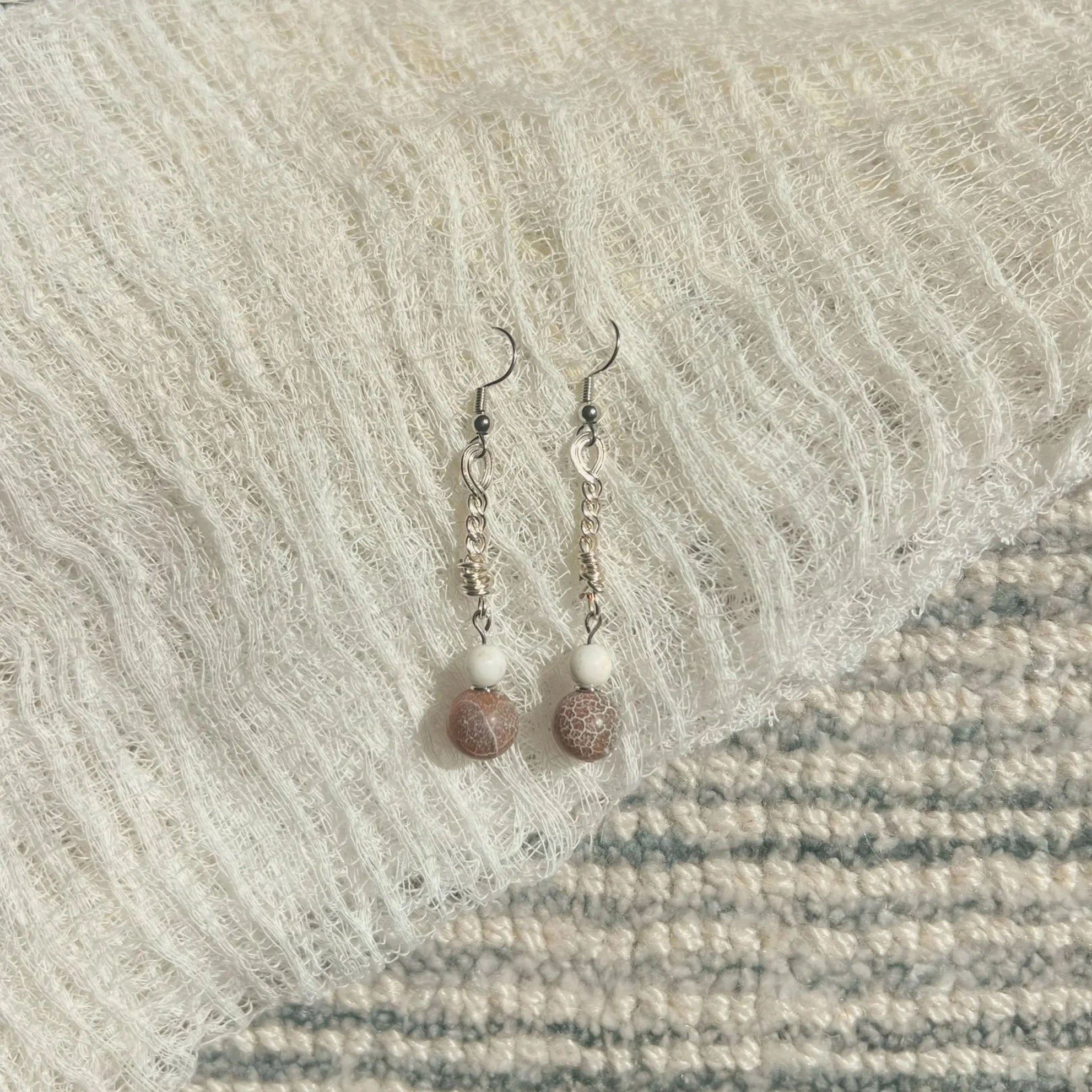 Crackled Brown Agate & Howlite Twisted Chain Earrings - $12 |  Brown Agate symbolizes grounding, stability, and balance. This stone embodies warmth as well as stability, as mentioned earlier, reflecting its connection to nature and grounding energies