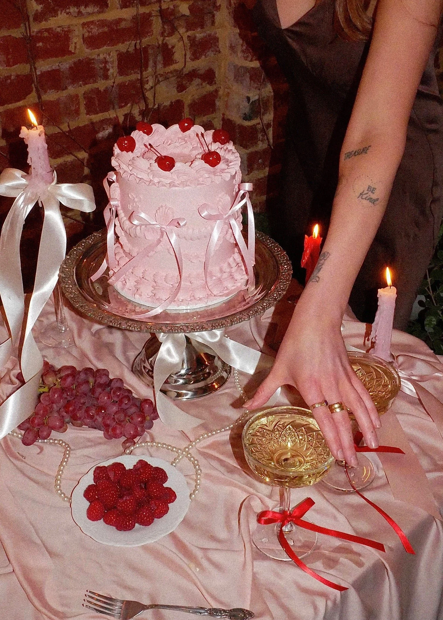 Table set up with cake, candles and wine glasses