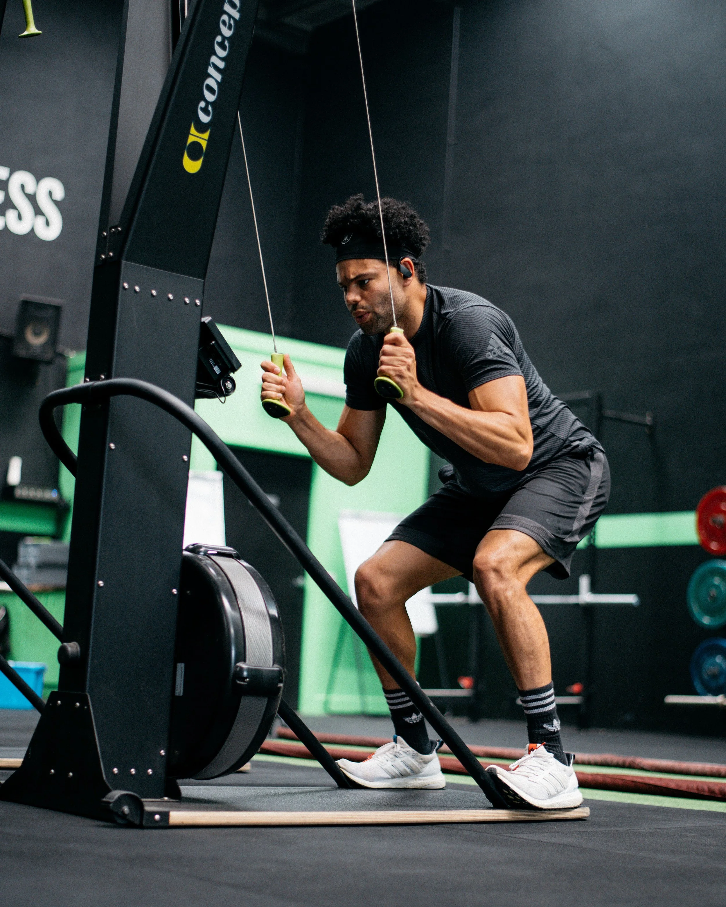 Male on ski erg machine inside a gym