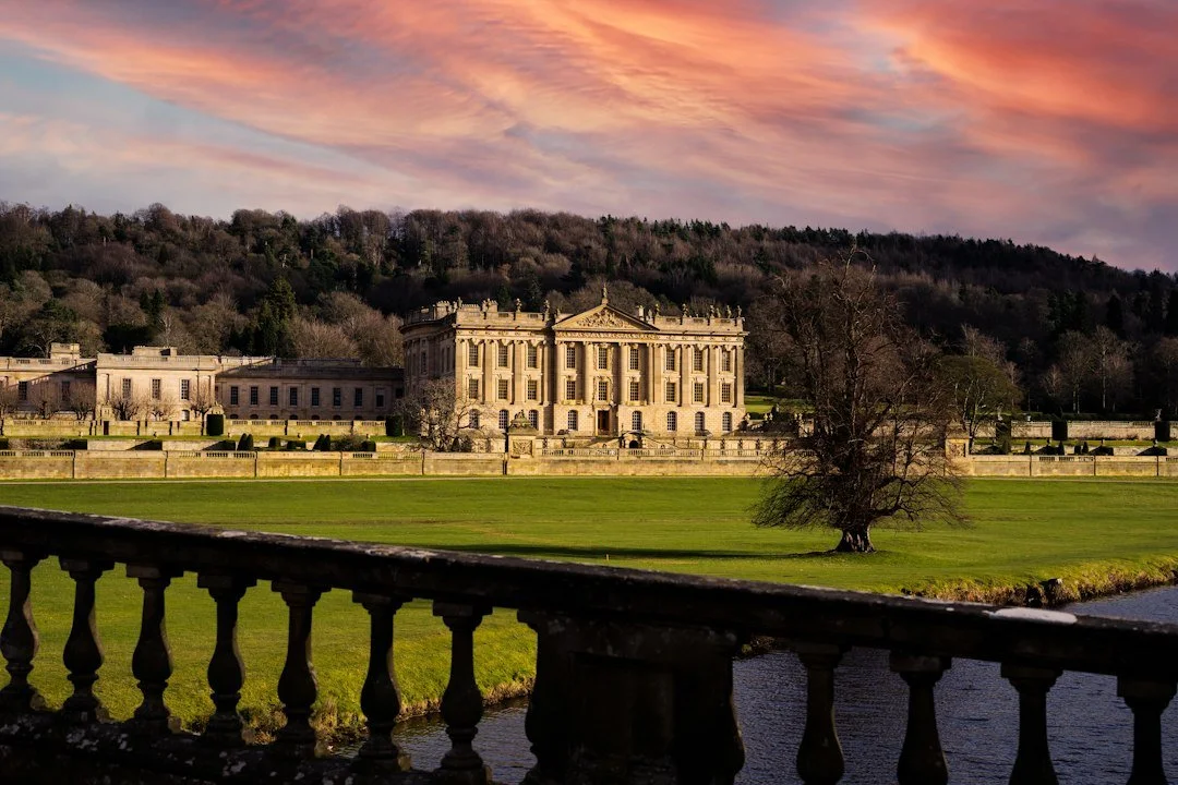 View of Chatsworth in Derbyshire with a pink sunset sky.