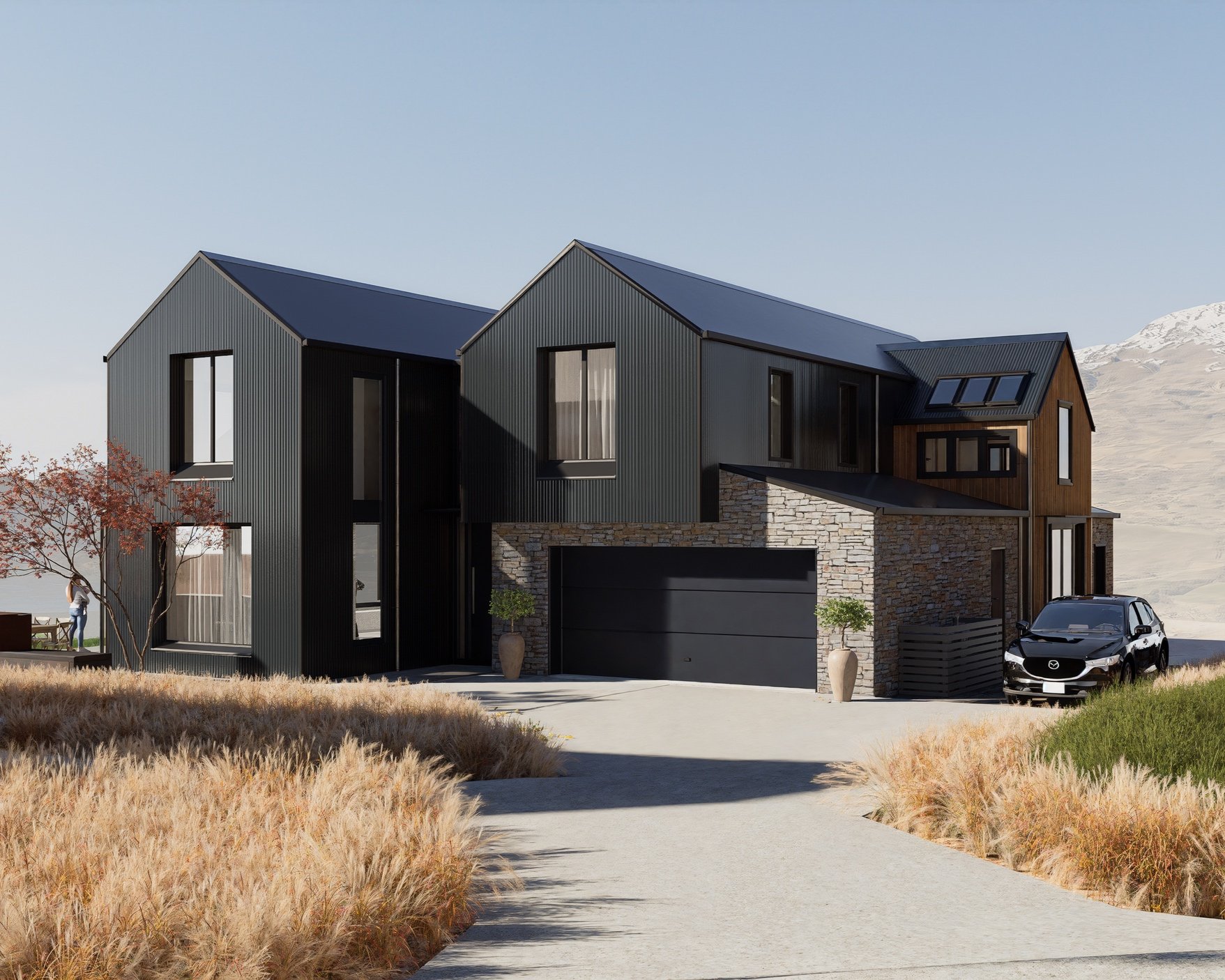 Modern two-story house with dark exterior, large windows, and stone accents, surrounded by dry grasses and shrubs, with a black car parked in the driveway. Designed by Wanaka / Queenstown architects, Hark Architects, based in Wellington, NZ.