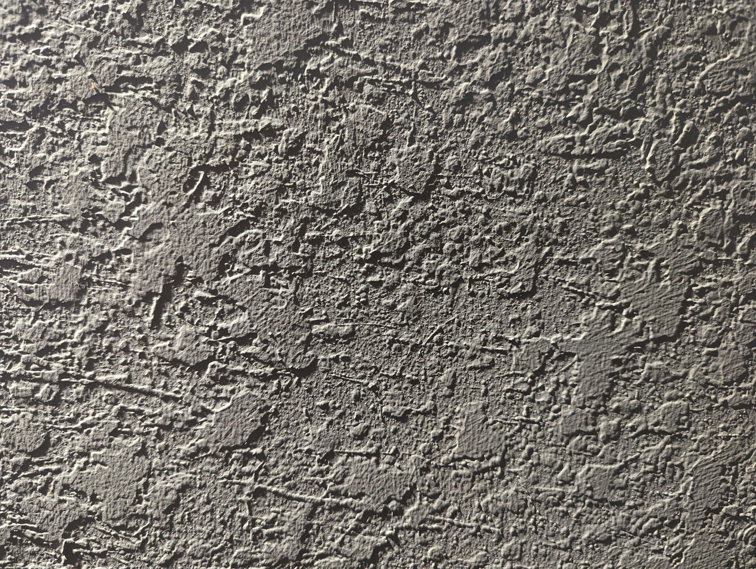 Close-up of a textured, rough, gray concrete surface.