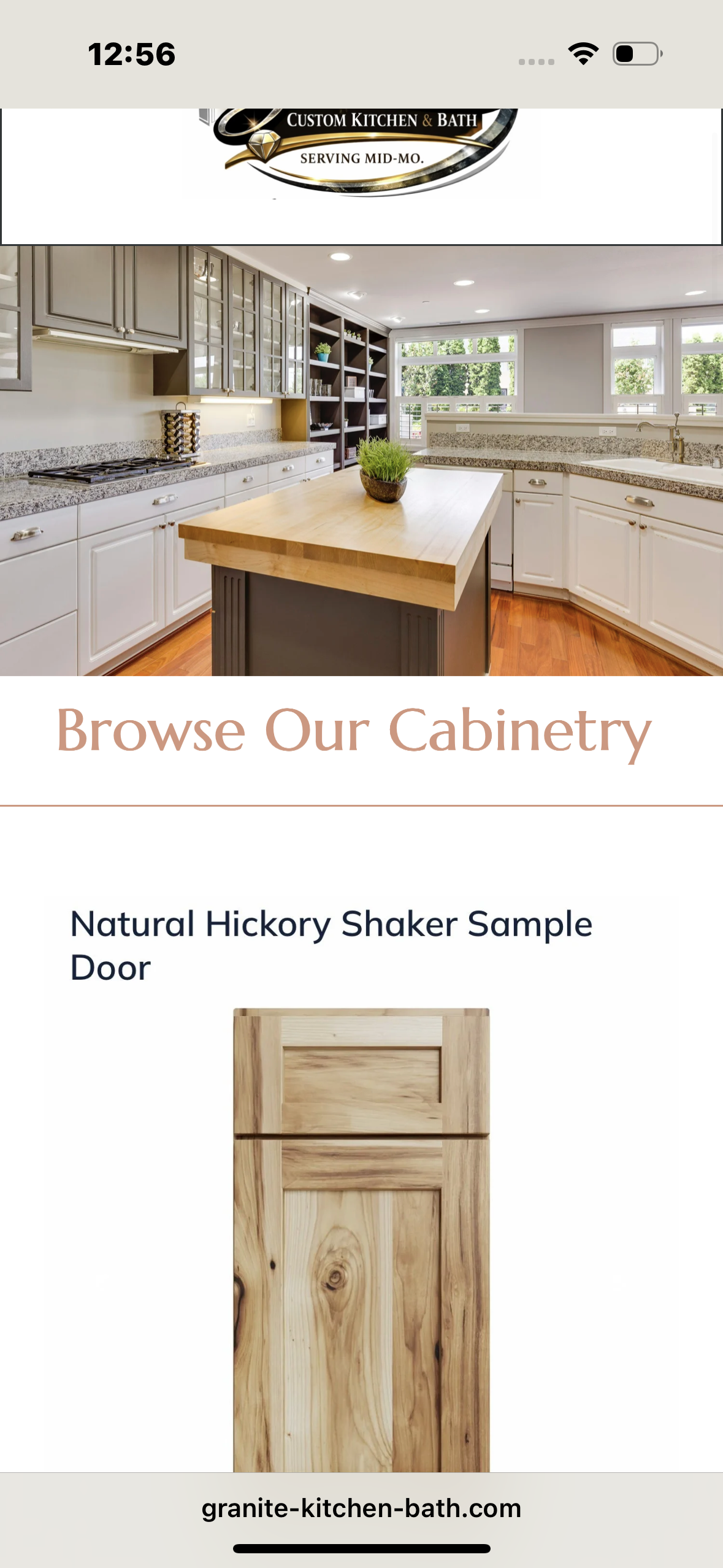 A modern kitchen with white cabinets, granite countertops, and a central kitchen island with a wooden butcher block top. Large windows bring in natural light, and there are open shelves and potted plants. A brochure for custom cabinetry with a pictur