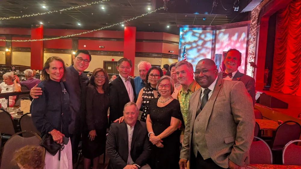 Dr. Neal with a group at an indoor event