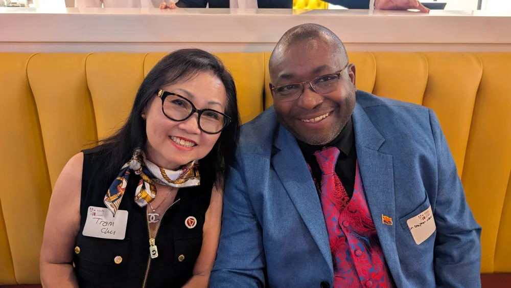 Dr. Neal and a woman smiling while seated together at a gathering