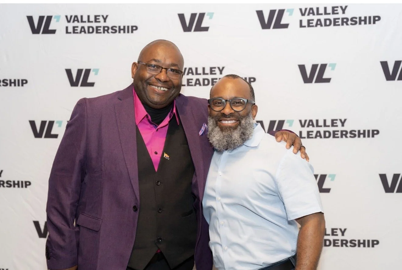 Dr. Neal and a man posing in front of a Valley Leadership backdrop