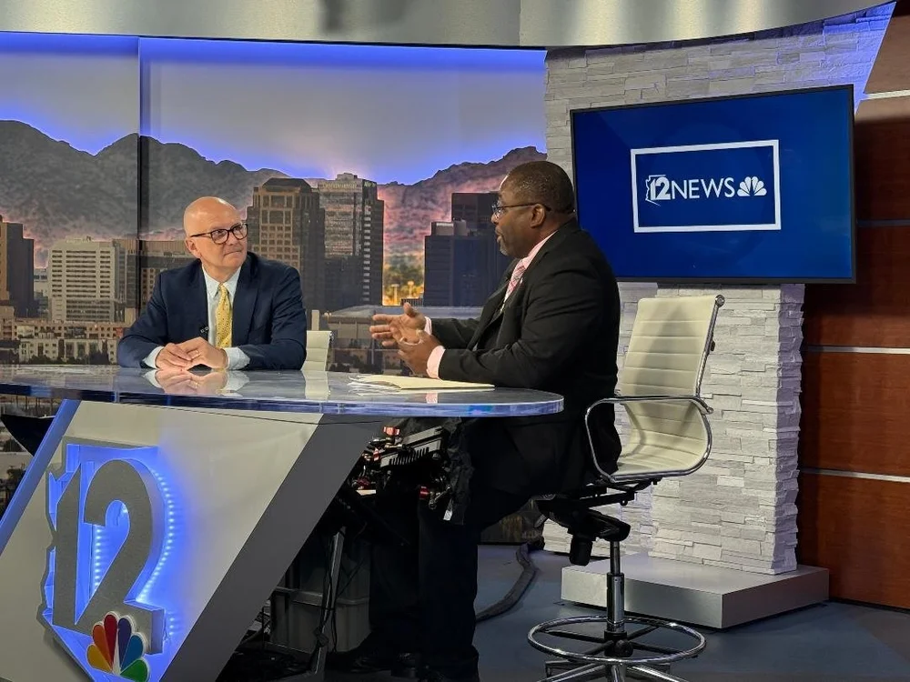 Dr. Neal speaking with a host at the 12 News studio desk