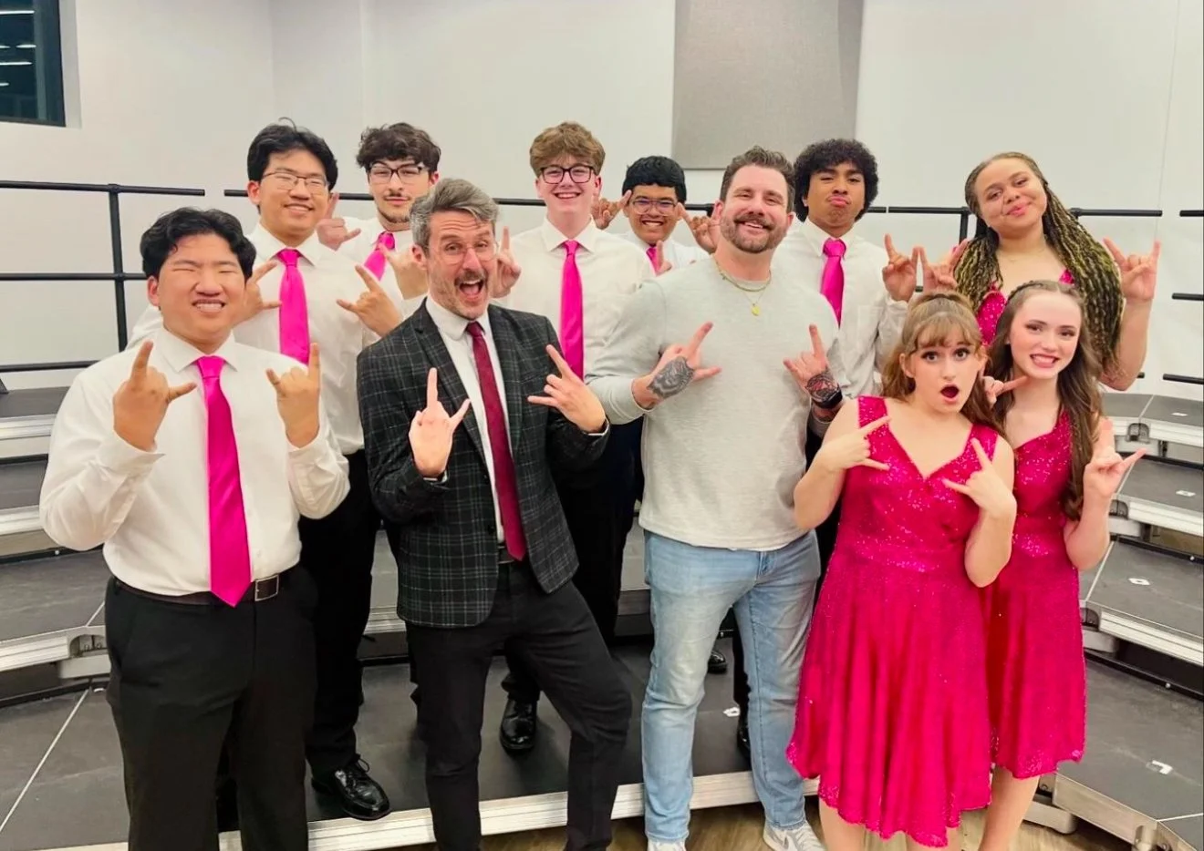 Dr. Neal posing with a group dressed for a performance