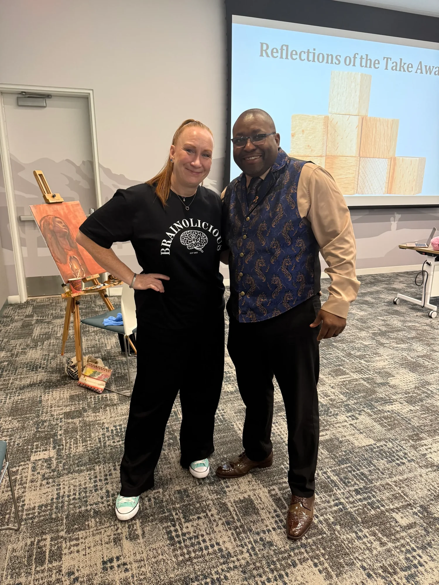 Dr. Neal and a man standing together in a classroom