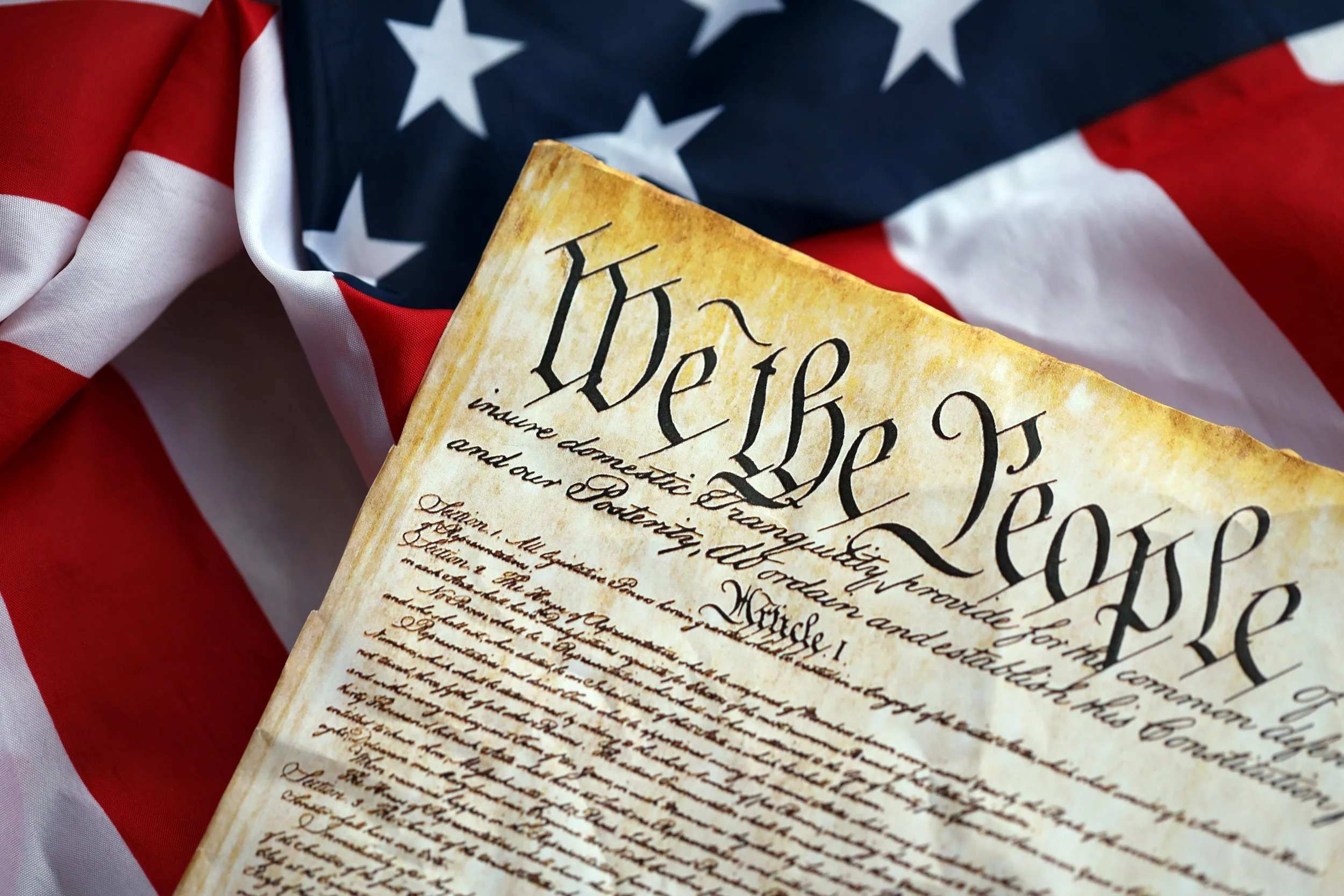 Close-up view of the U.S. Bill of Rights document placed on an American flag.