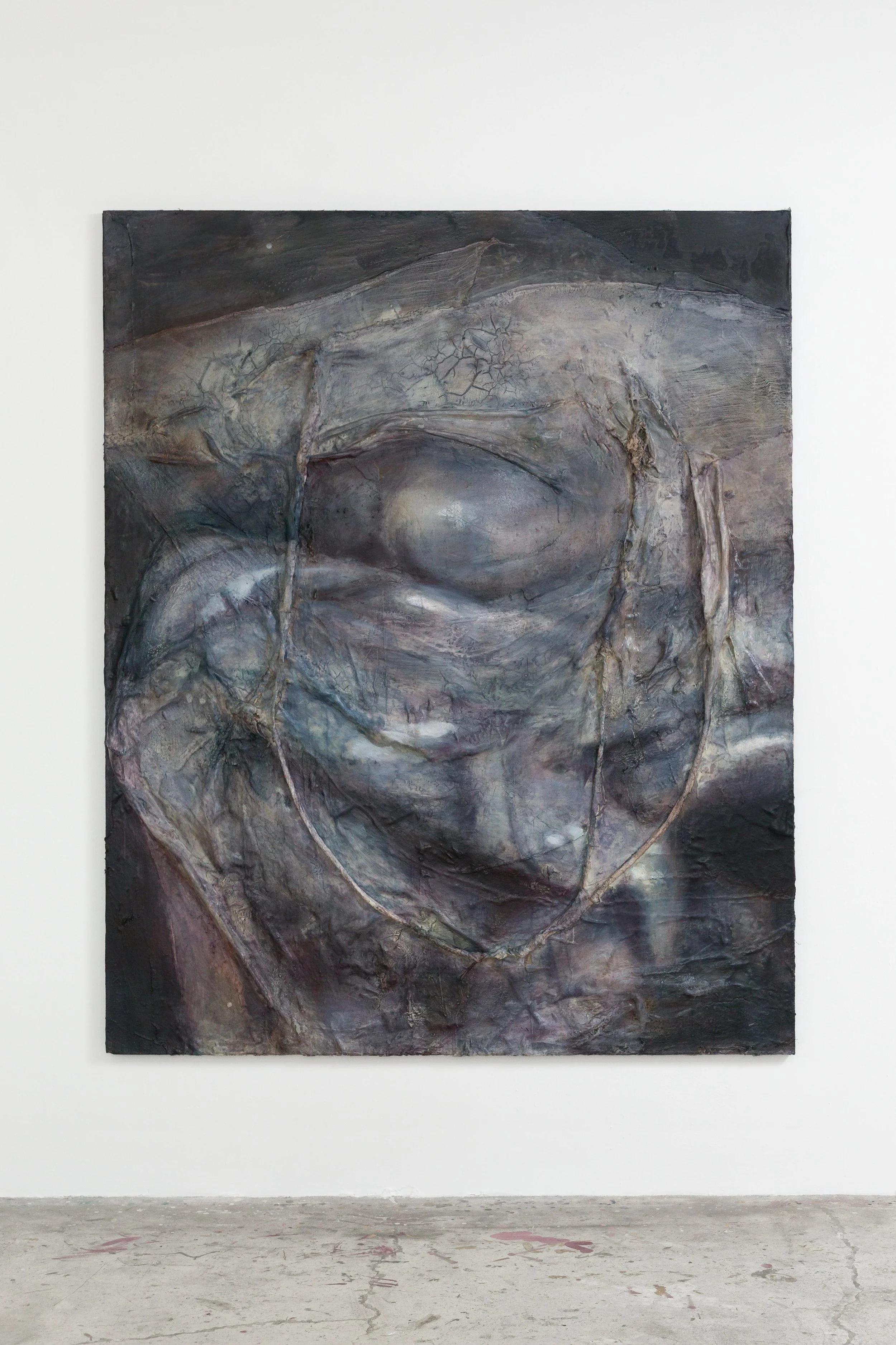 A large abstract painting with dark and muted tones hangs on a white gallery wall, depicting a distorted face with rough textures and cracked details.