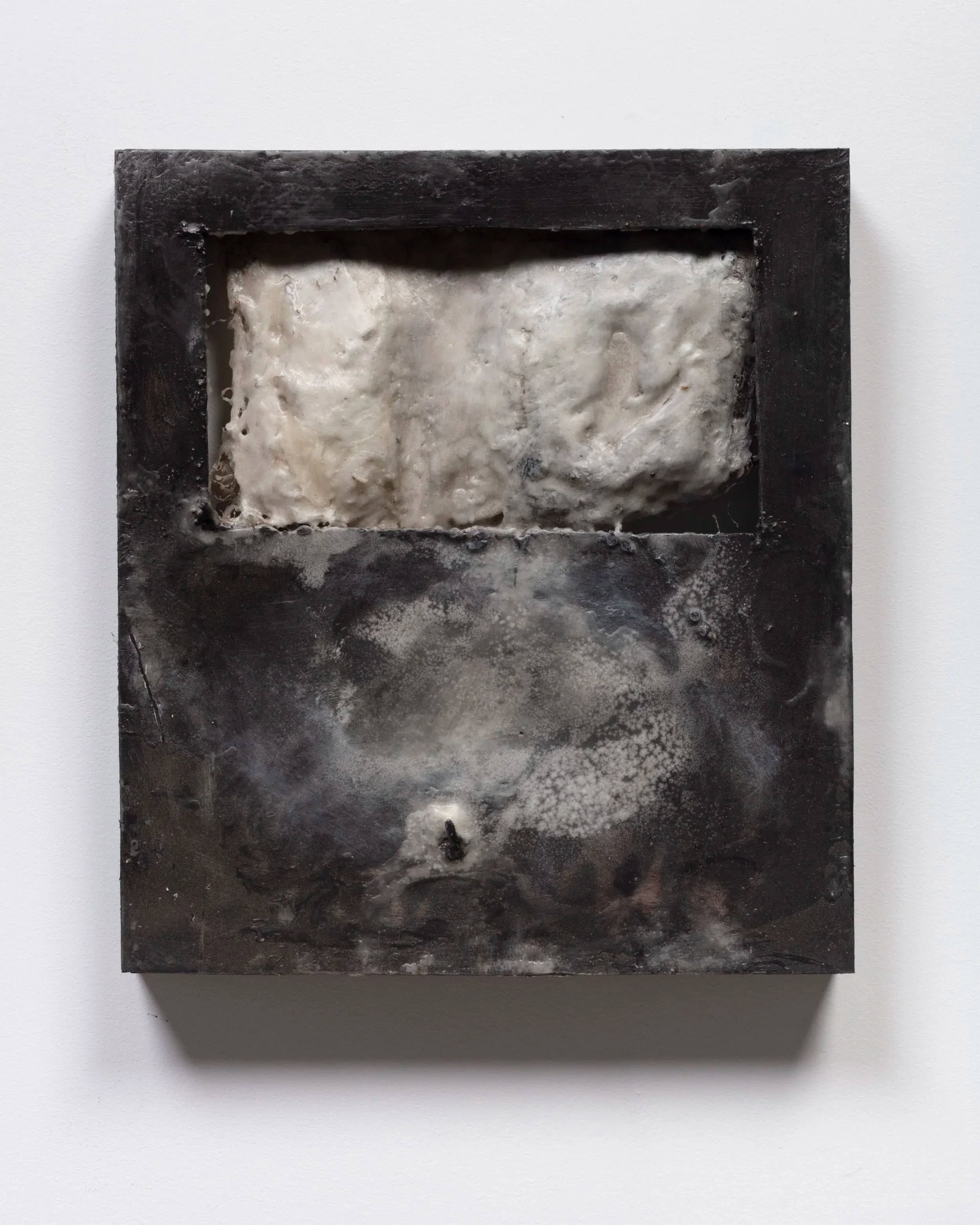 Close-up image of a metal painting with a rough, textured interior surface, used for casting or forming materials, set against a plain white background.