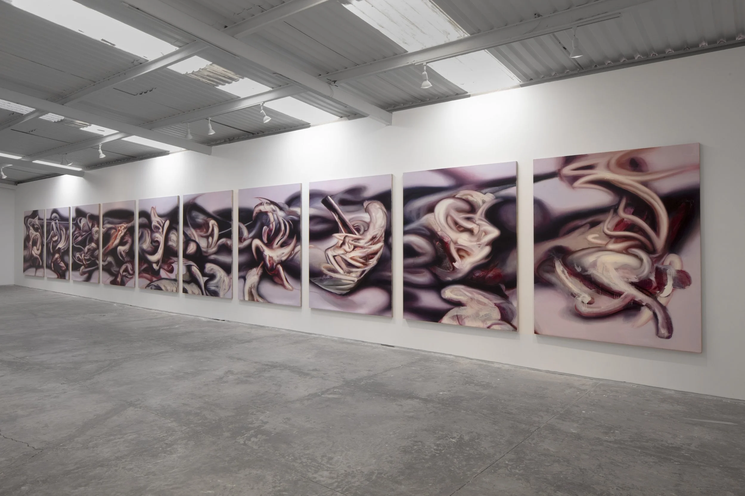 Abstract multi-panel artwork featuring swirling, smoke-like forms in shades of black, white, pink, and red displayed on a gallery wall.