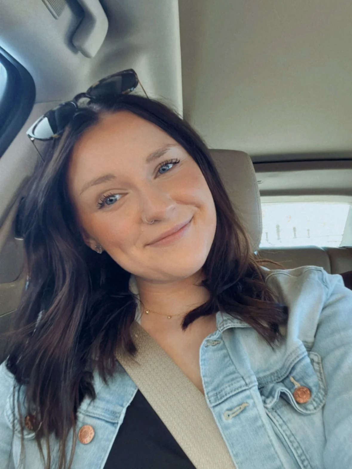 Owner of Stellar Celebrations LLC smiling in front of balloon arch backdrop
