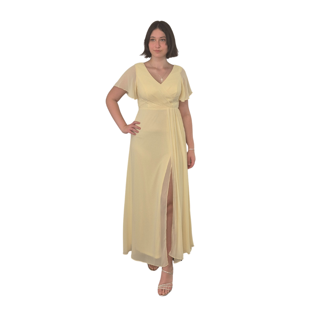 Sahara wearing a size 12 in the Clara Dress. Gorgeous flow to this piece, Chiffon overlay with pleat feature from the waist with spilt. Zip up back and subtle butterfly sheer sleeve. Also available in a size 10.