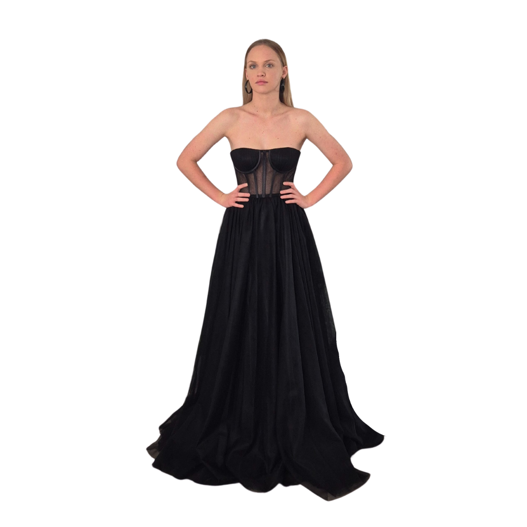 Bella is wearing the Bella Dress in a size 4. Absolute showstopper gown, full tulle skirt, sheer with corset style top half. Also available in a size 8.